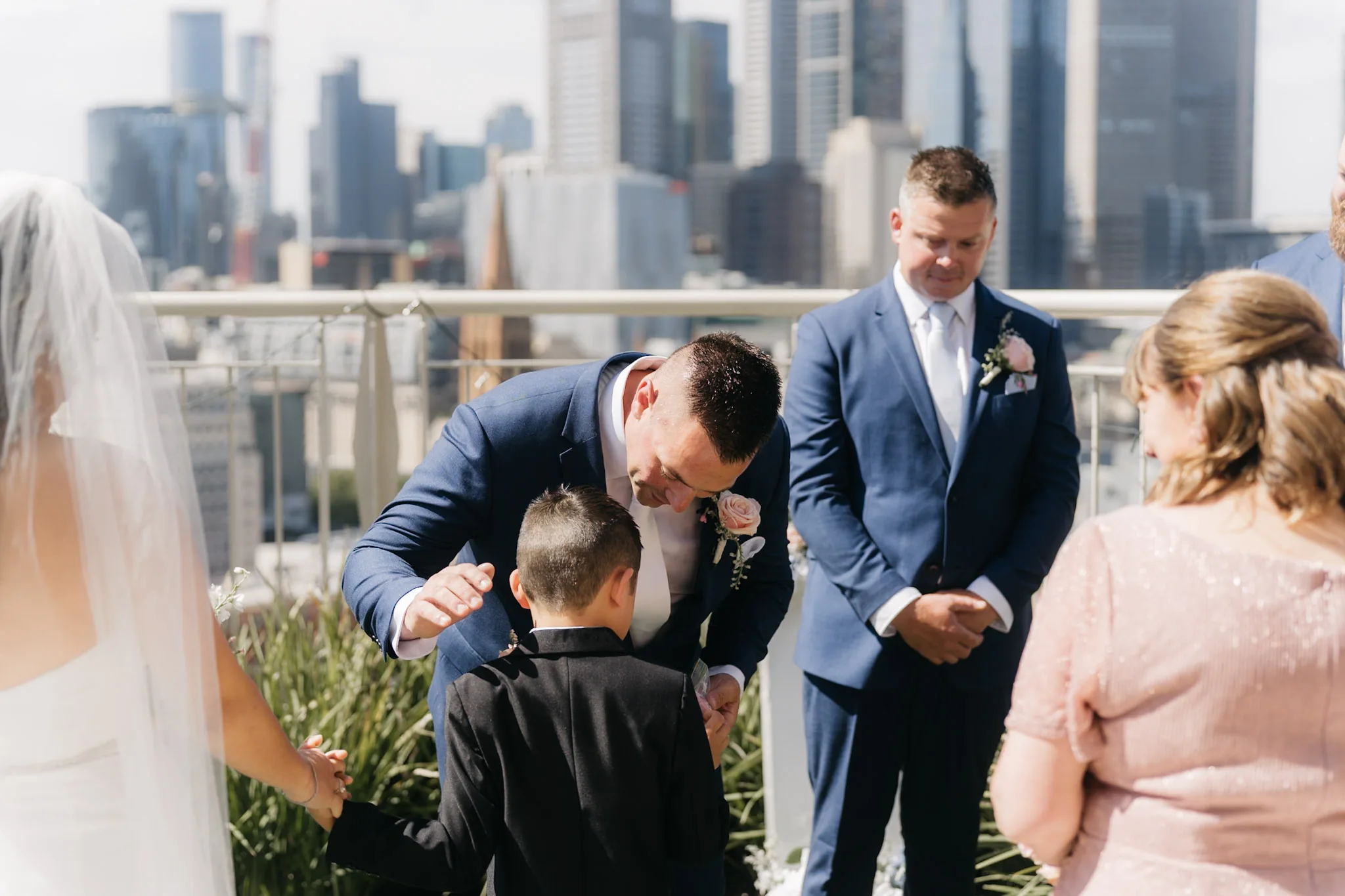 Rob bending to greet the young attendant at the ceremony