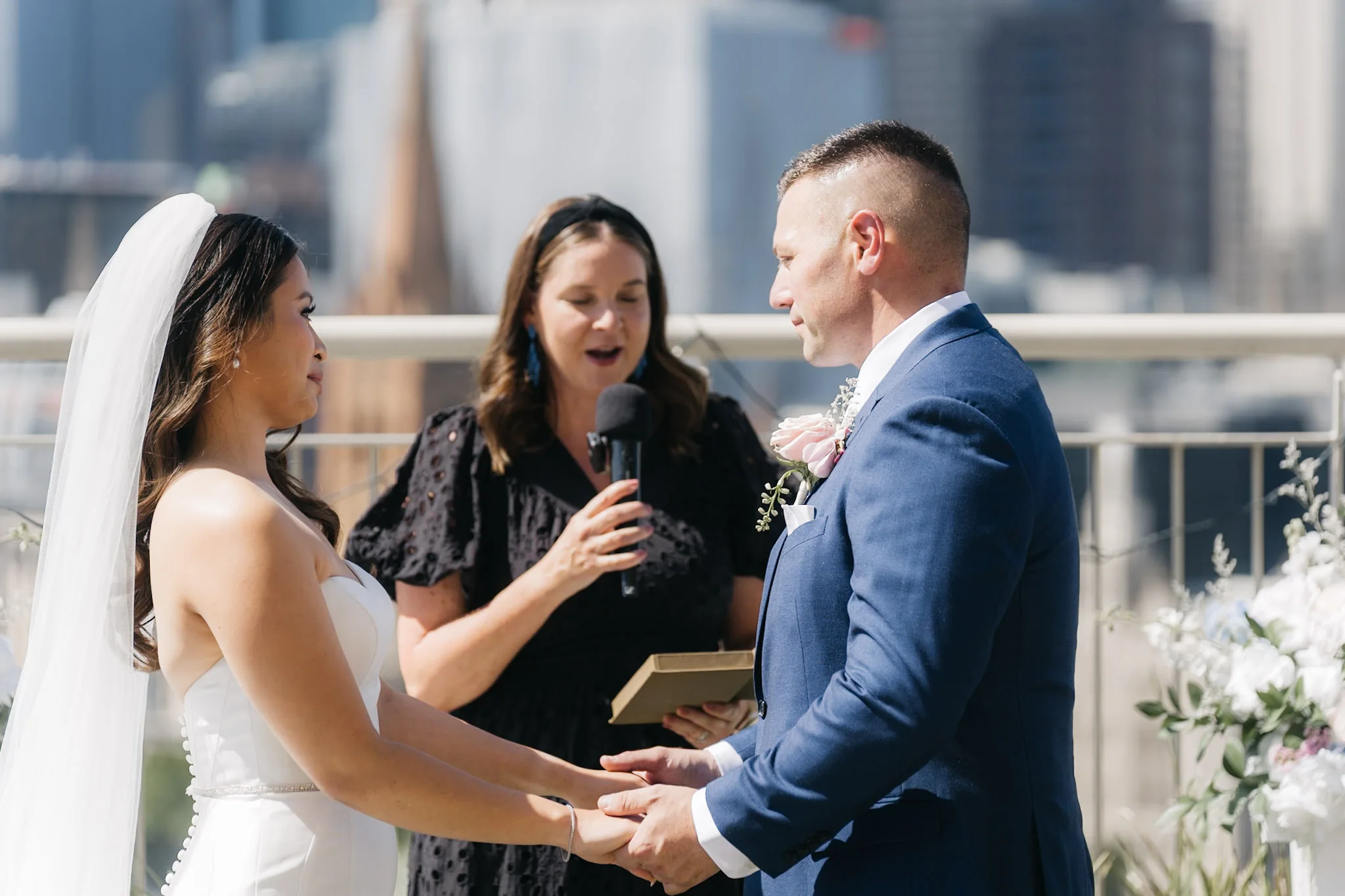Che and Rob laughing with their celebrant during the vows