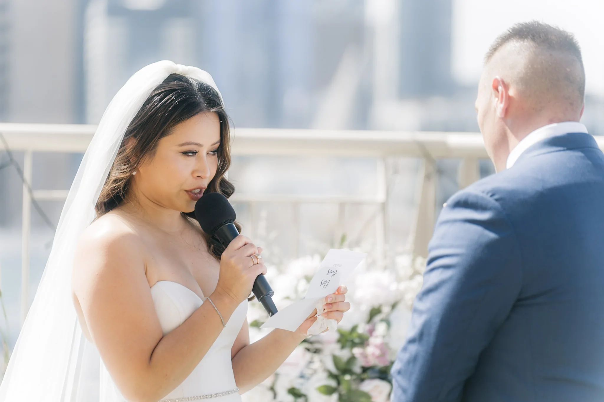 Che reading her vows with the city skyline behind her