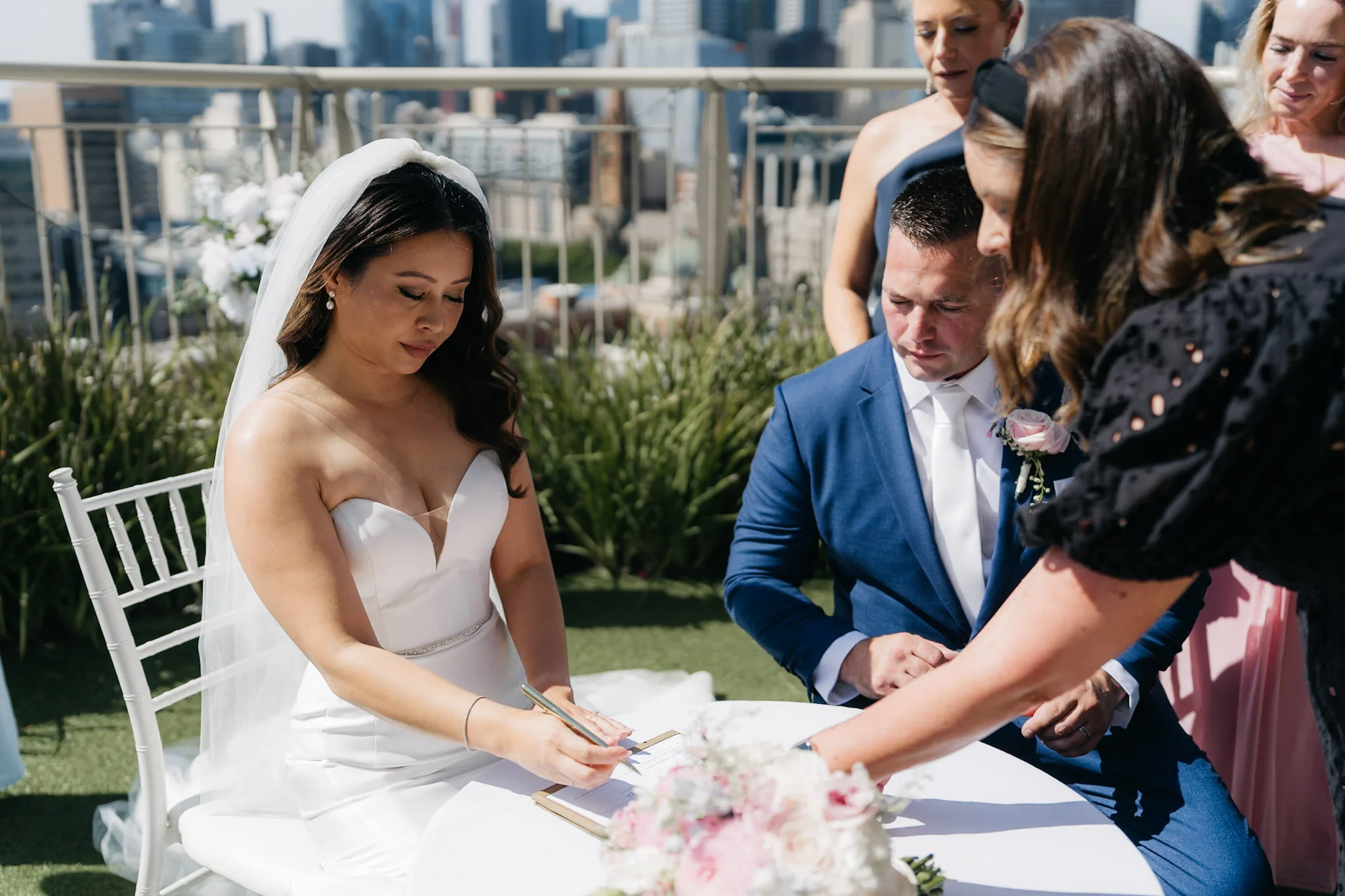Che and Rob signing their marriage documents on the terrace
