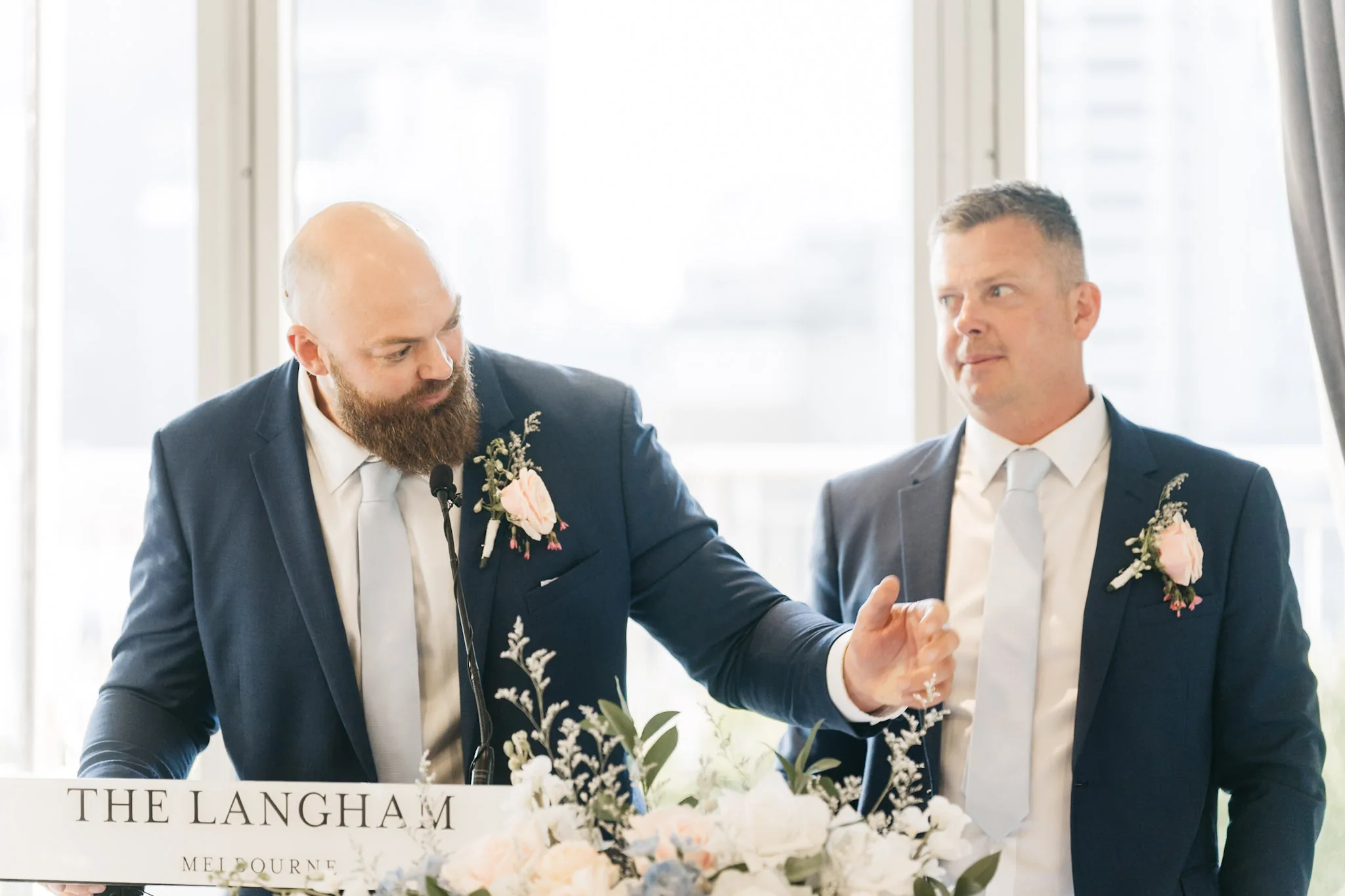 A groomsman sharing a story with Rob during the speeches
