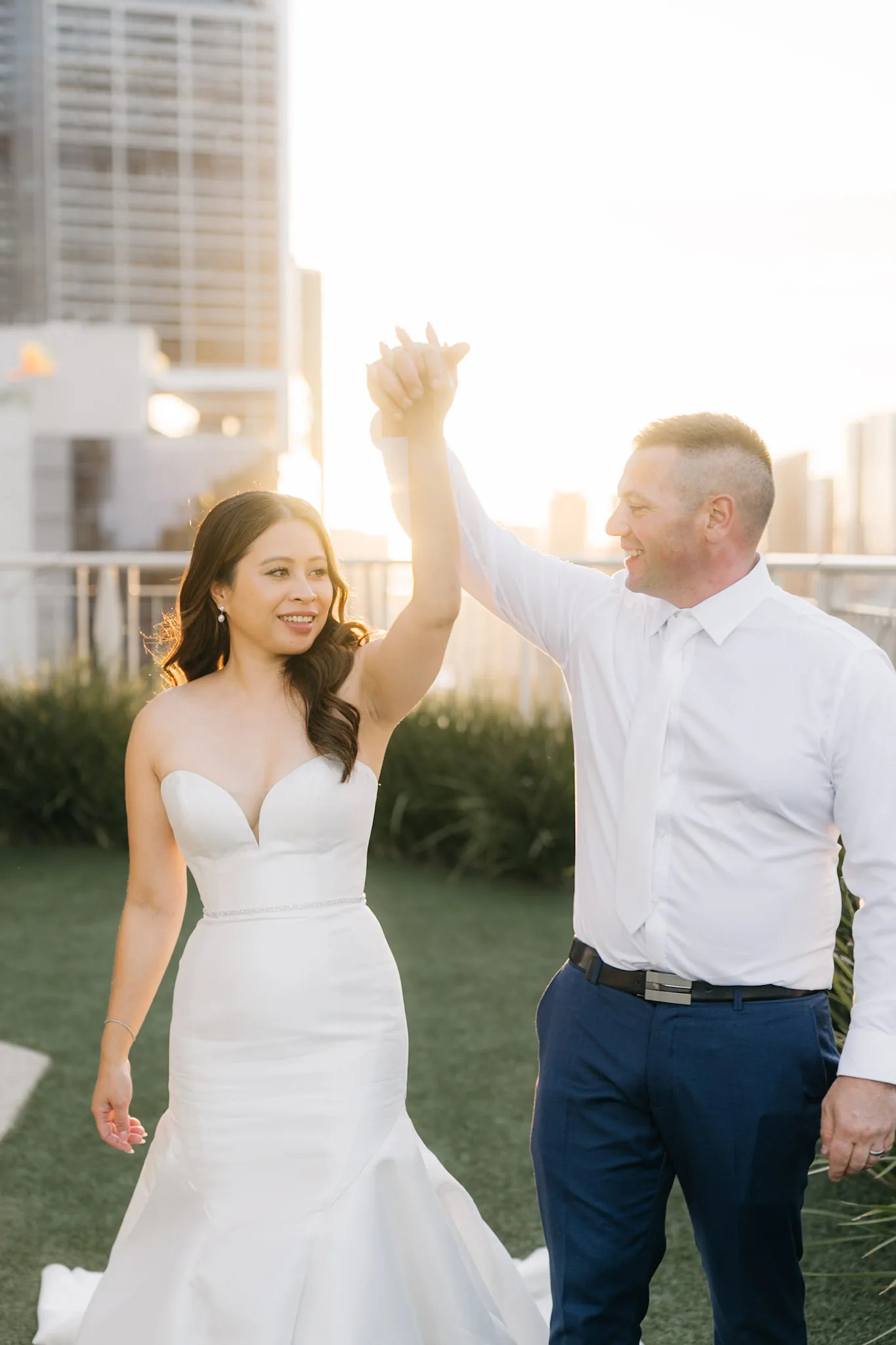 Rob twirling Che by the hand on the rooftop terrace