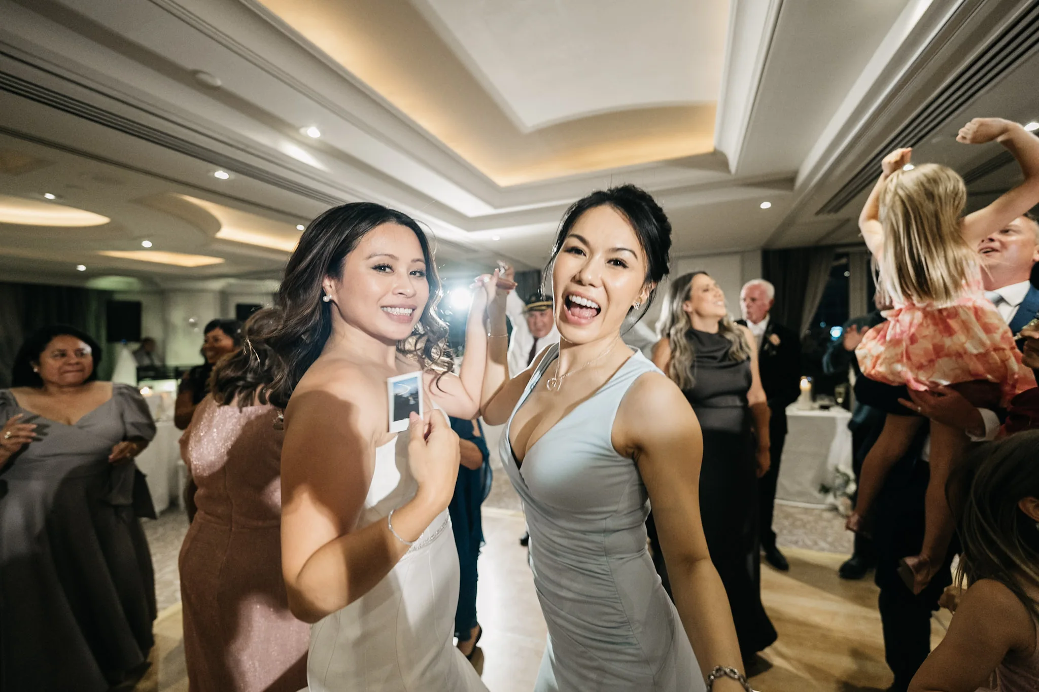 Two guests laughing together during the evening celebrations