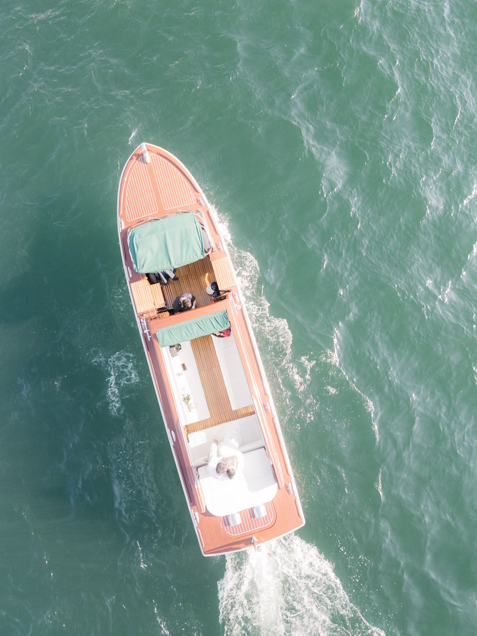 A top-down view of the boat tracing a clean line through Lake Como