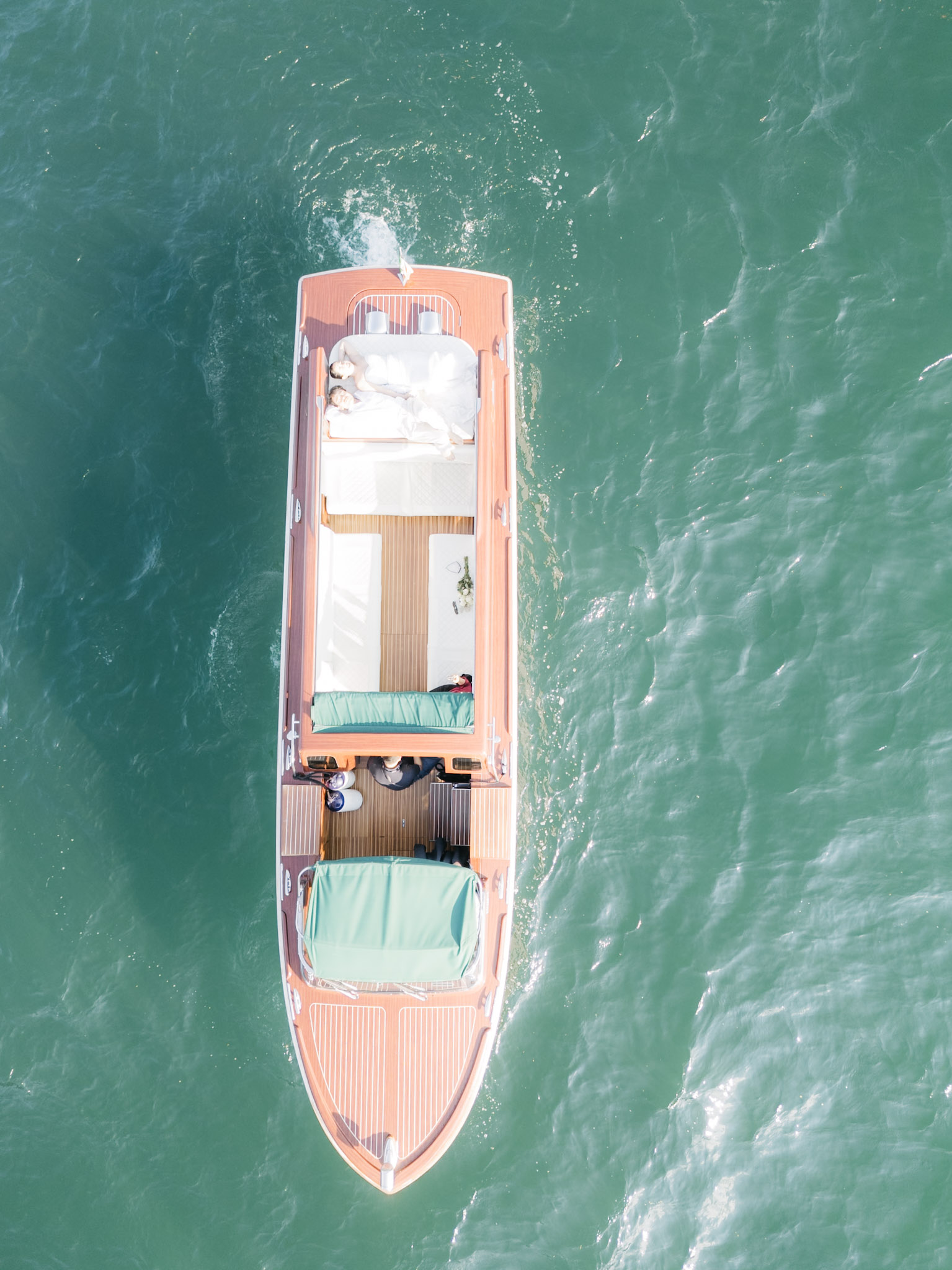 A graphic top-down frame of the boat on deep green water