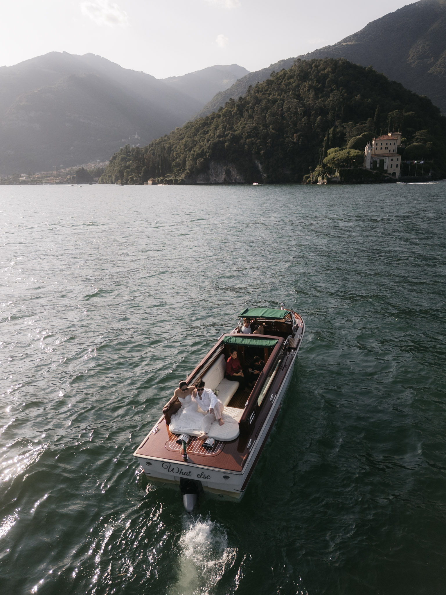 The boat heading toward the mountain shoreline on Lake Como