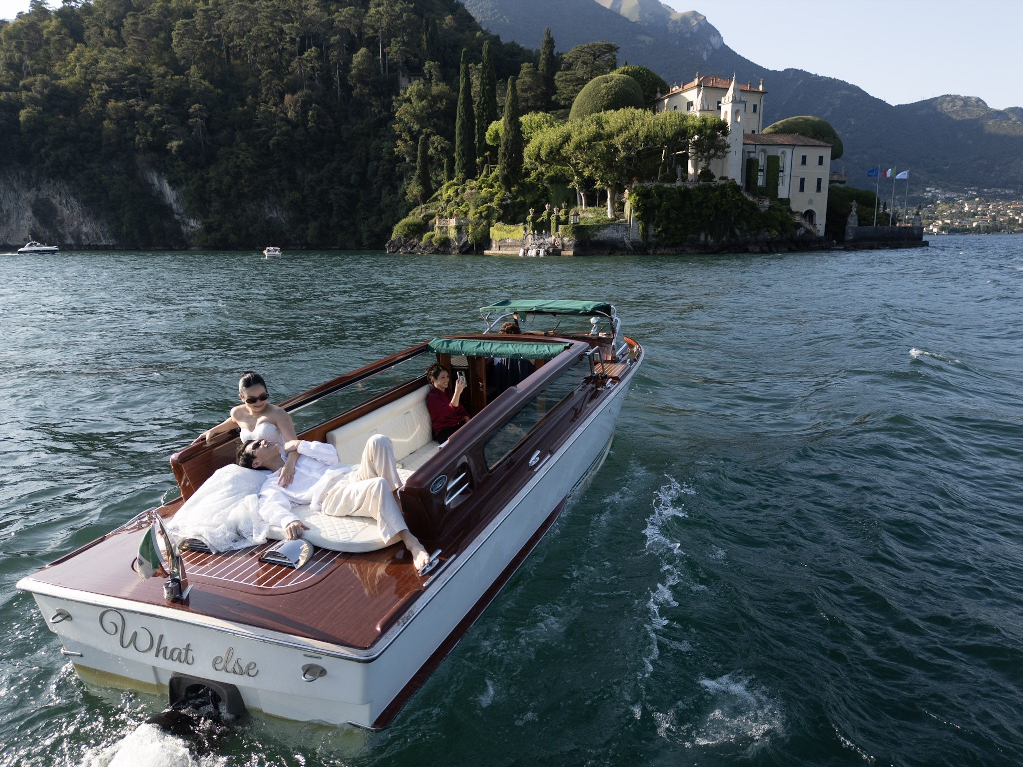 Hau and Feng relaxing on the boat with Lake Como behind them