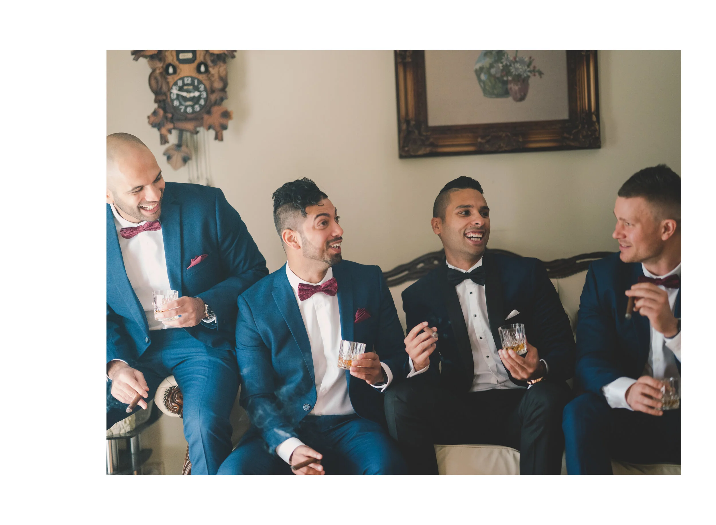 Groom laughing with his groomsmen during preparations