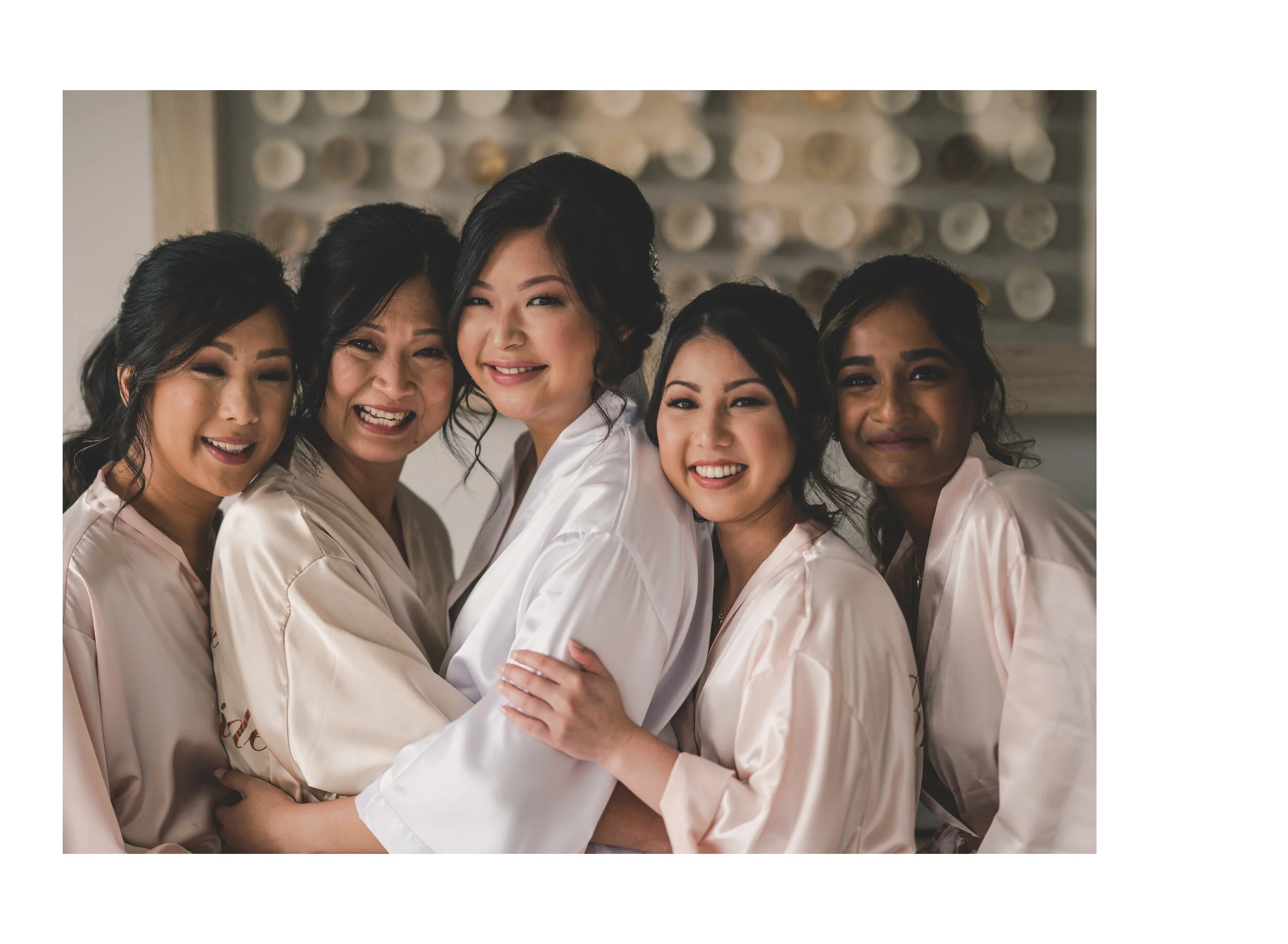 Bride laughing with her bridesmaids during morning preparations