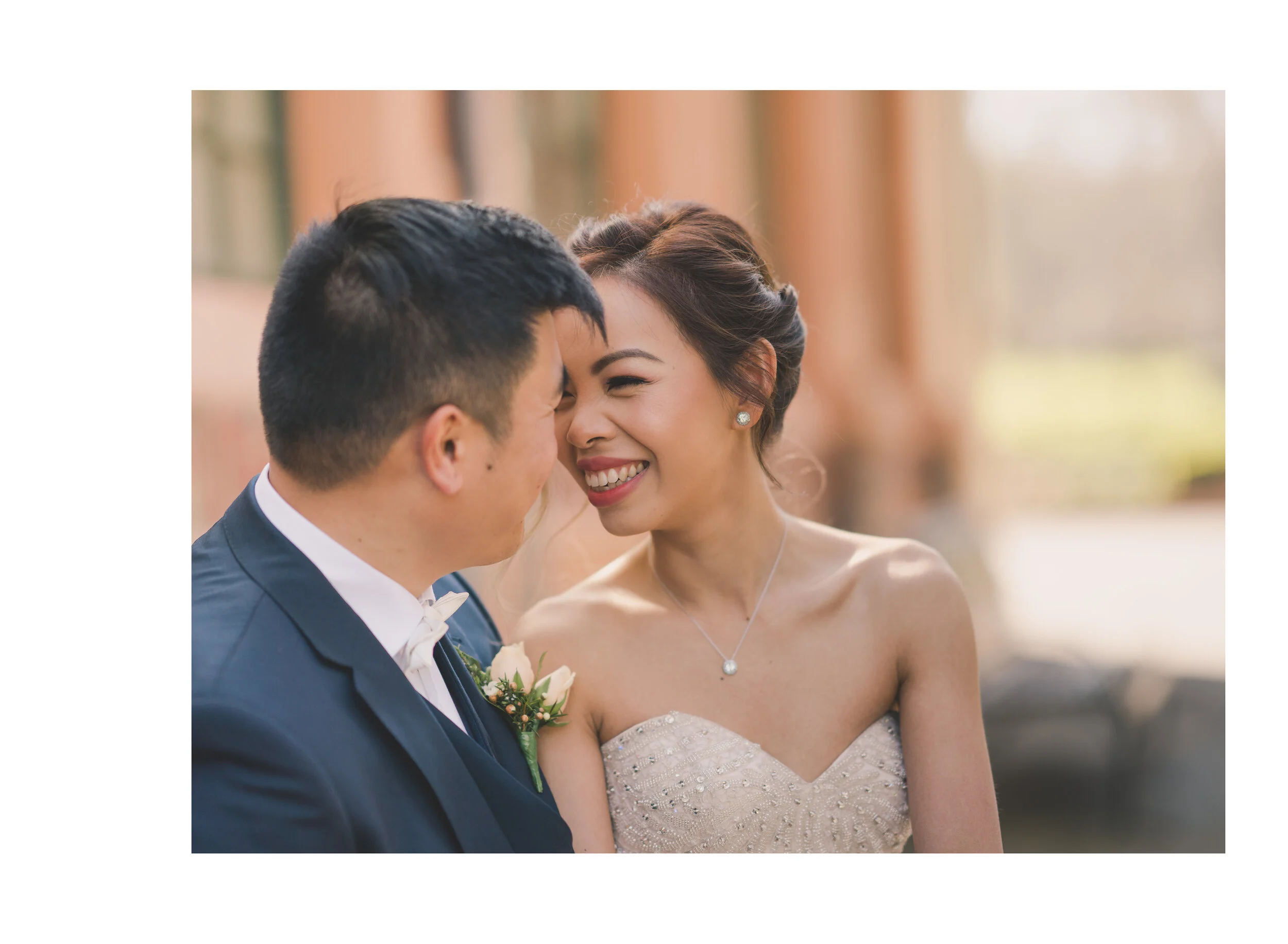 Bride laughing with the groom during their portraits
