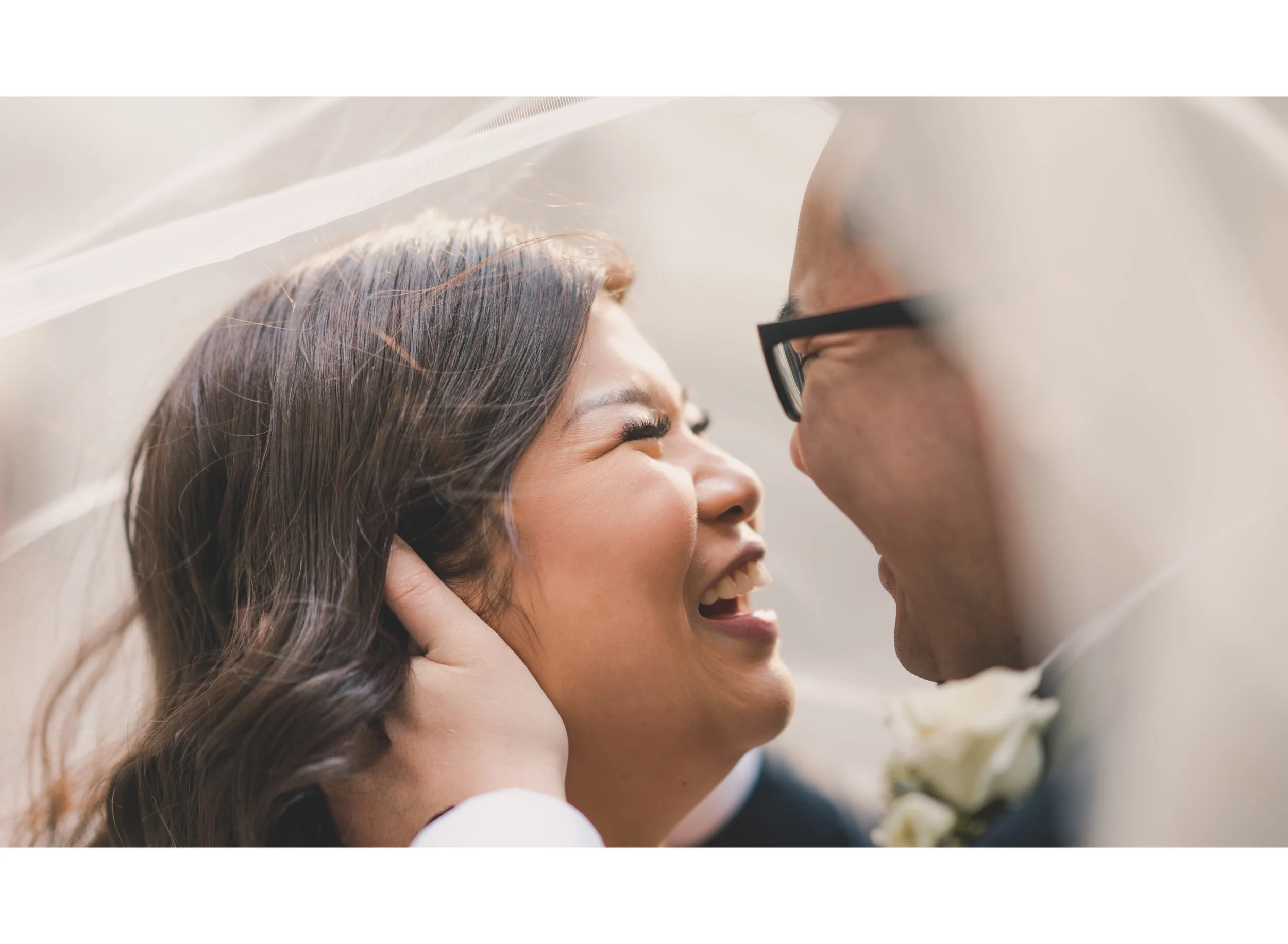 Newlyweds laughing together in an intimate close-up
