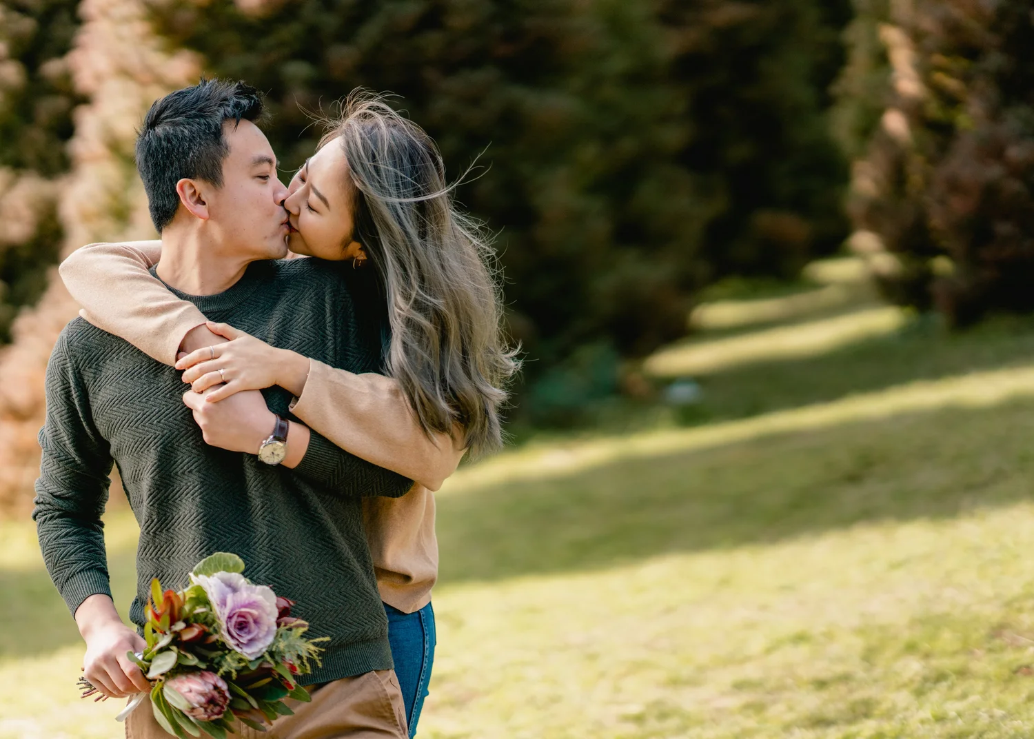 Couple laughing together in a garden