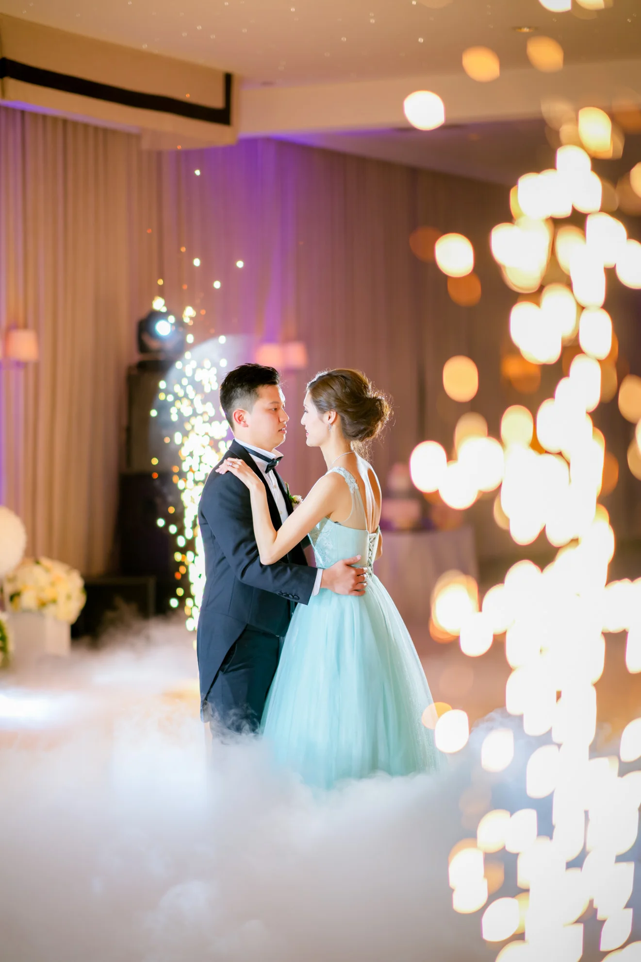 Newlyweds entering their reception through sparks