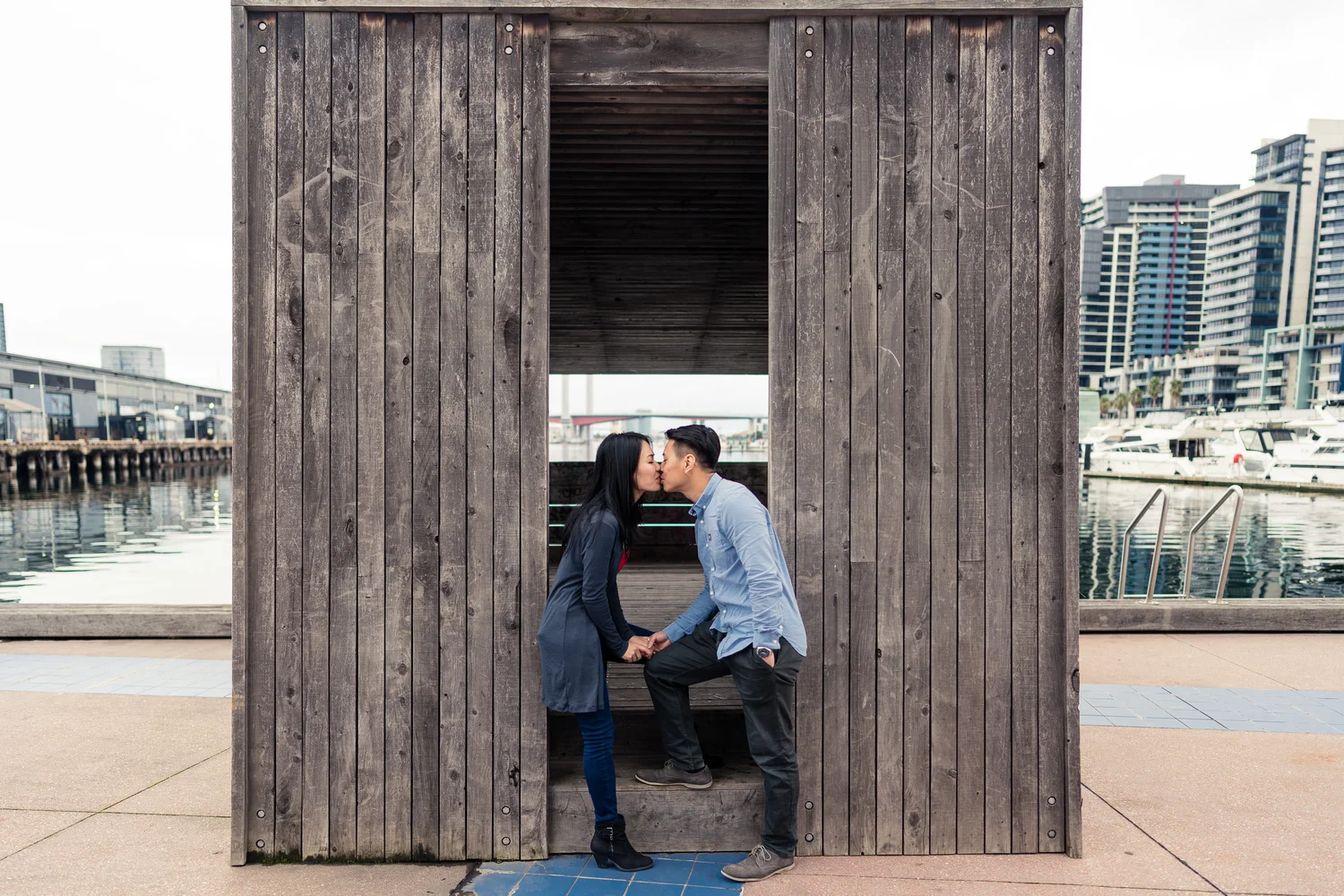 Urban wedding portrait framed by a timber doorway