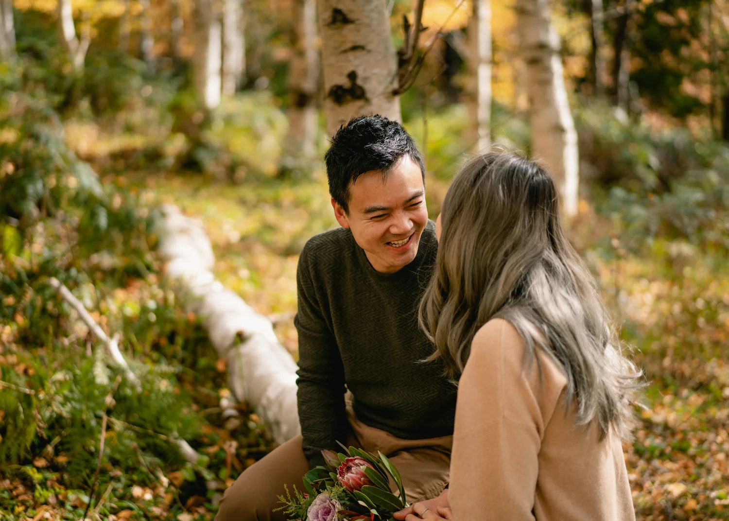 Couple laughing together in warm garden light