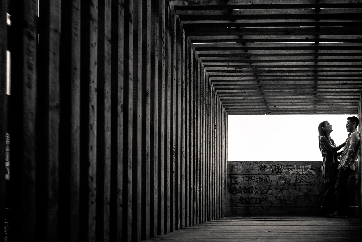 Black-and-white silhouette beneath repeating architecture