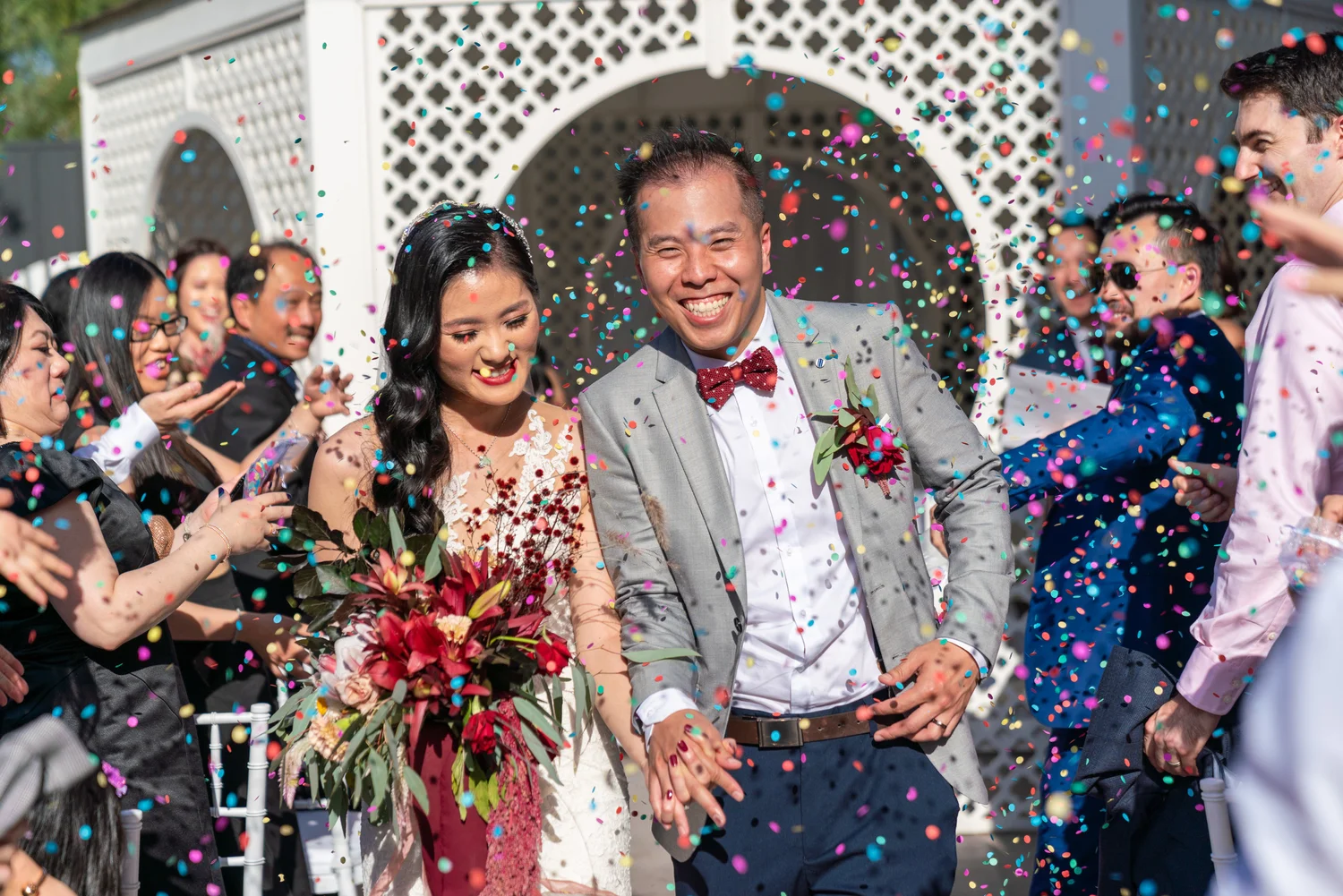 Newlyweds celebrating through a shower of confetti