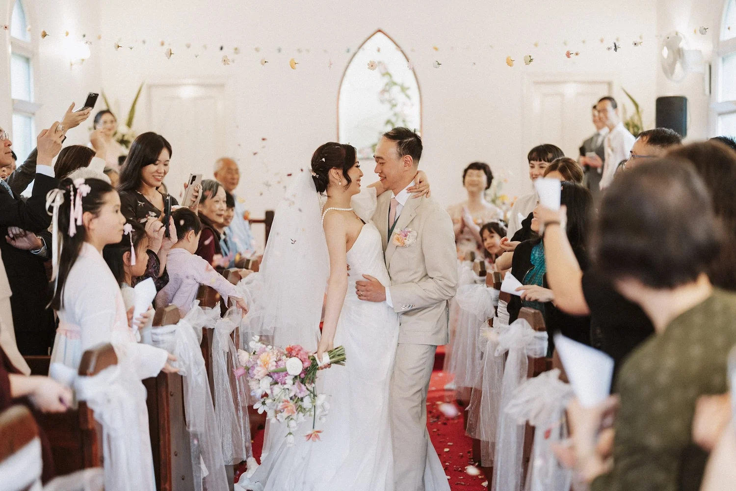 A joyful ceremony exit through falling confetti