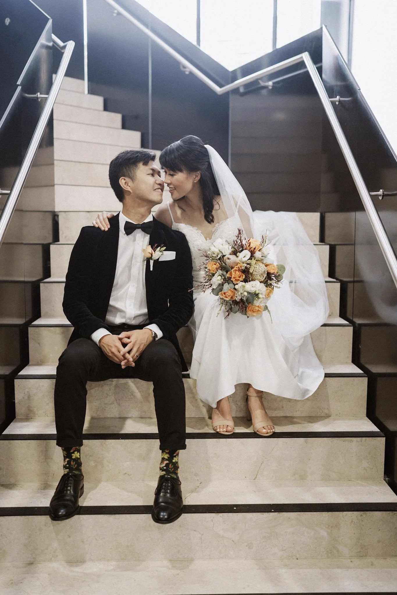 Newlyweds sharing a quiet moment on a staircase