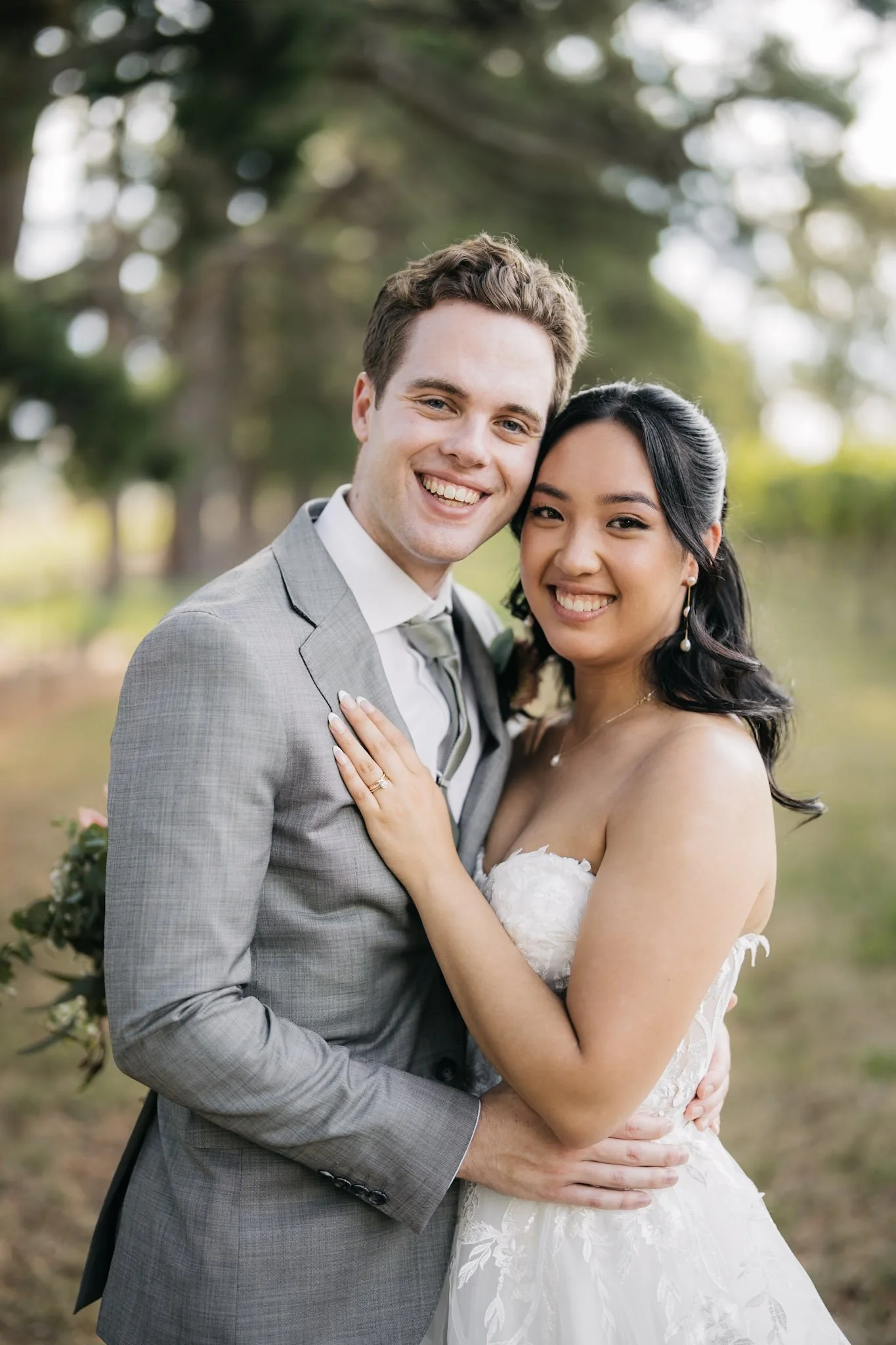 Newlyweds smiling together in soft garden light