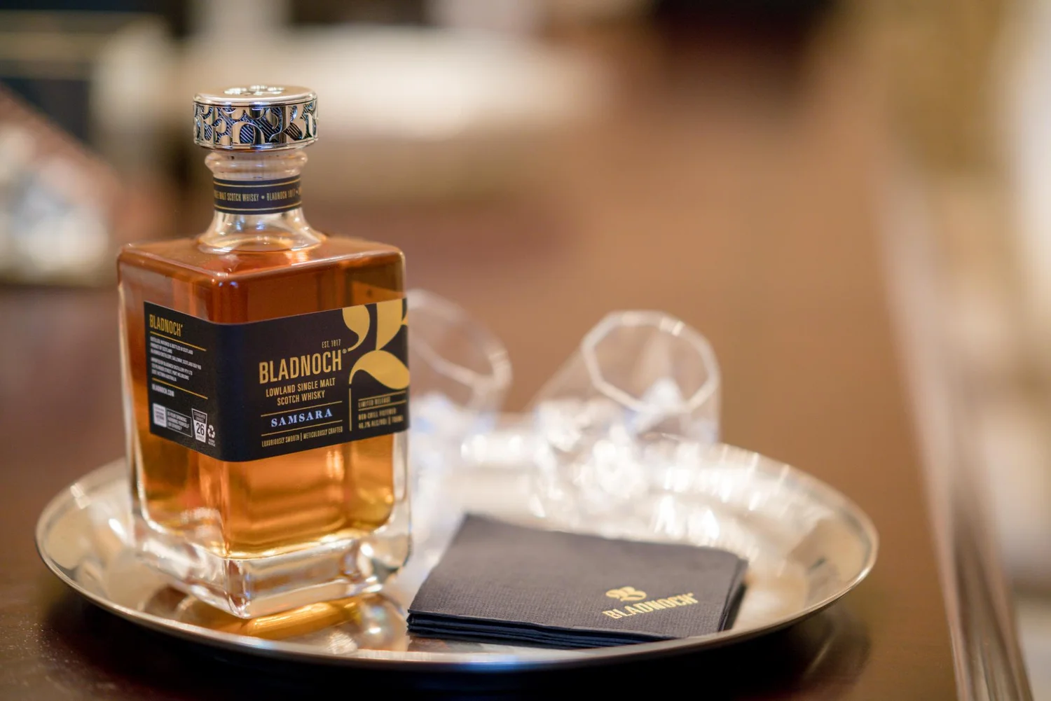 Bladnoch Samsara whisky bottle and tasting glass on a dark tray