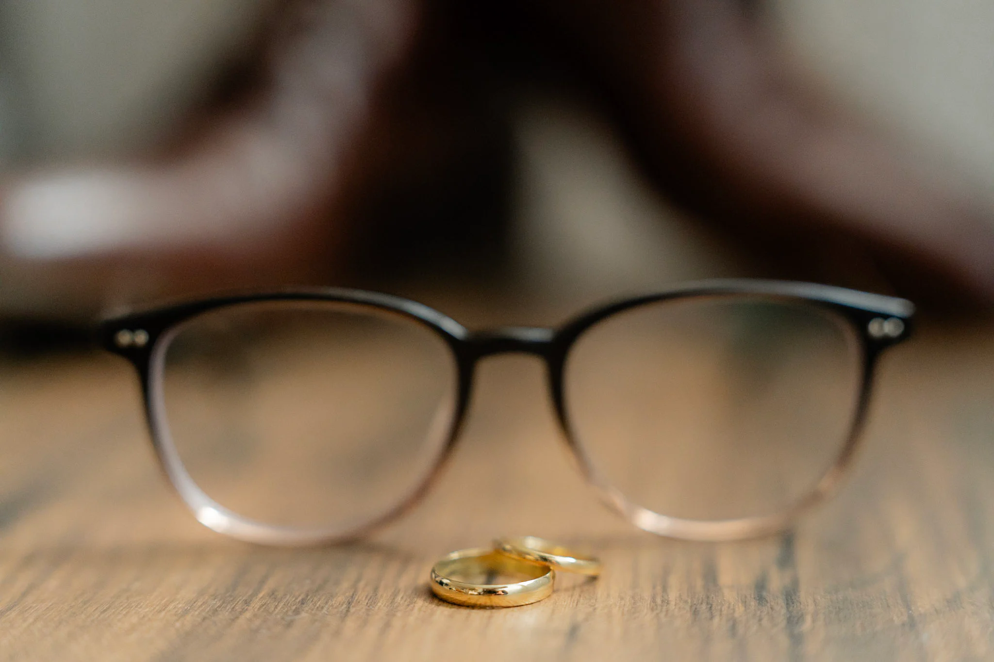 Ron and Joy's wedding rings arranged beside Ron's glasses
