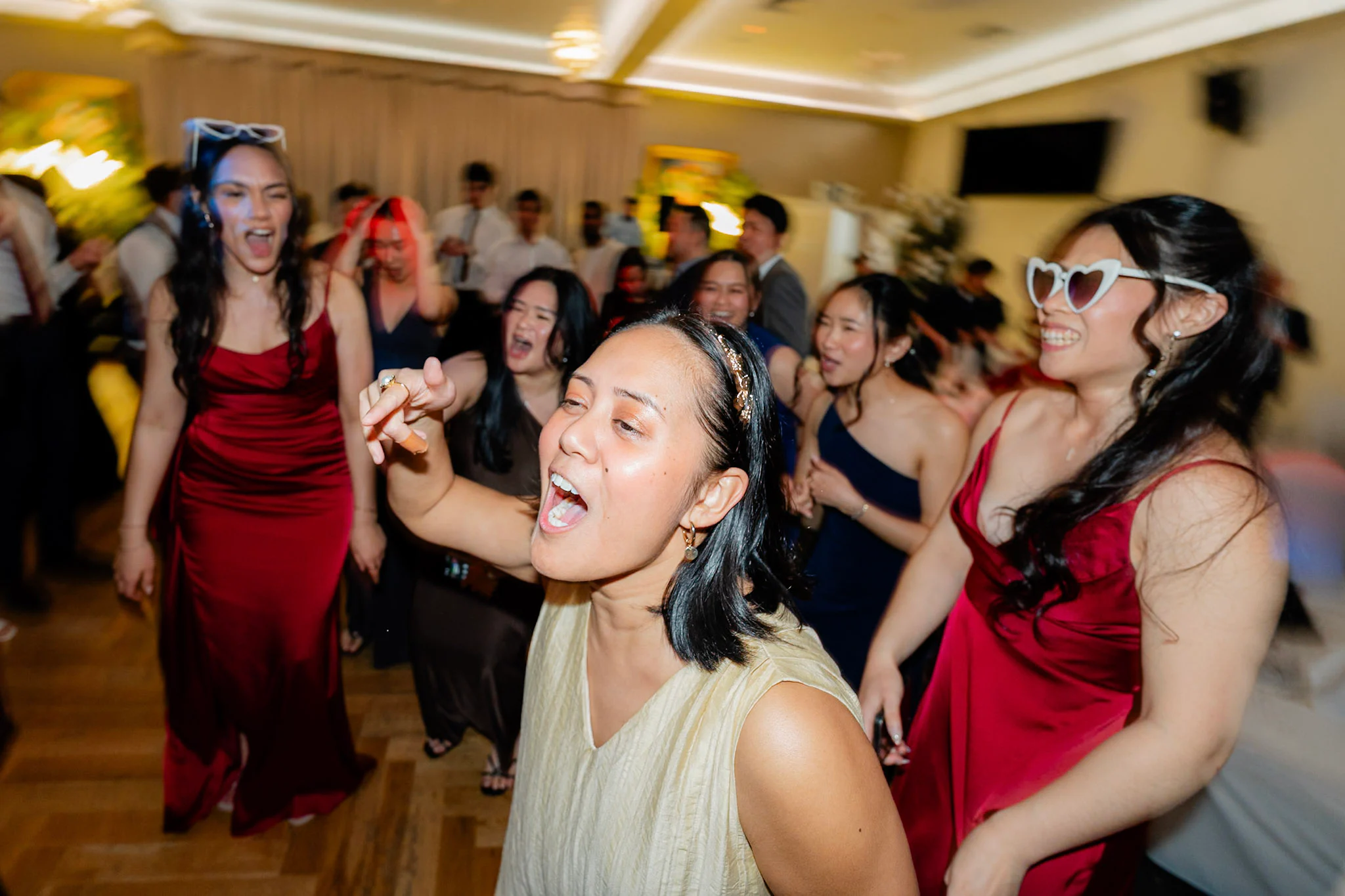 Friends singing together on the crowded dance floor