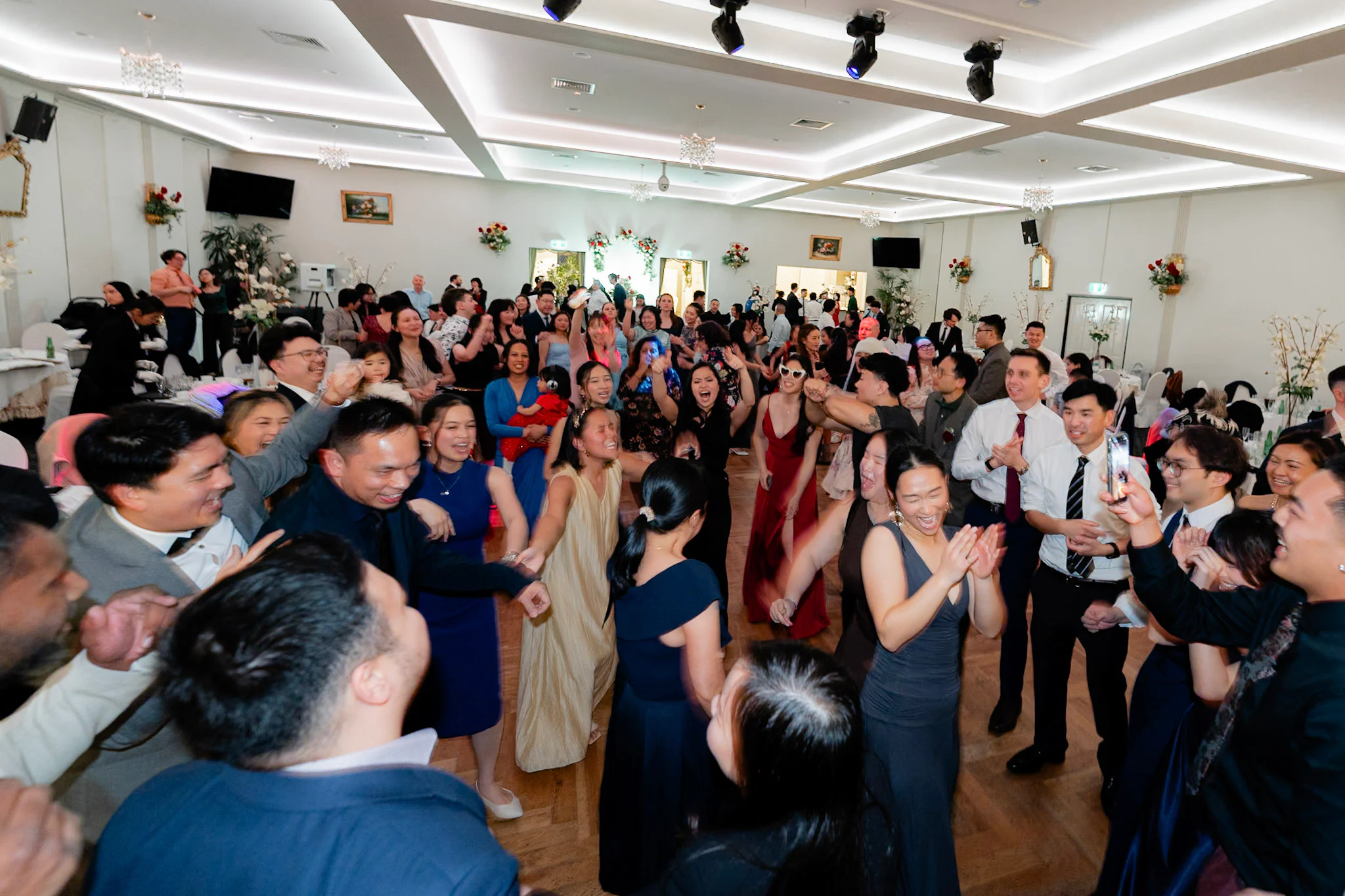 The whole wedding crowd filling the dance floor