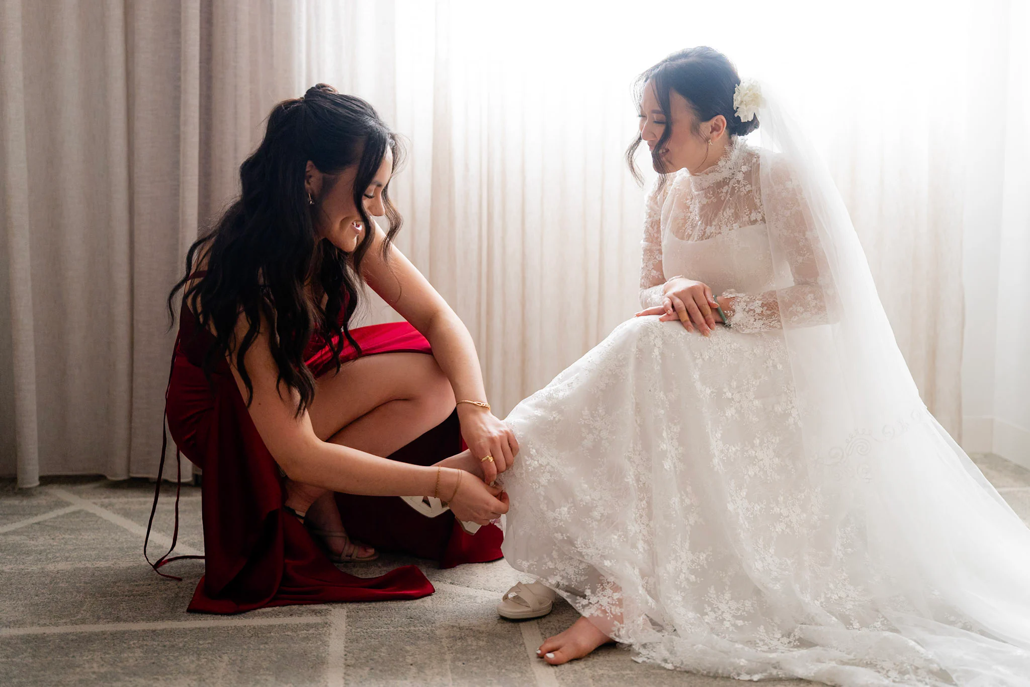 A friend helping Joy with her wedding shoes