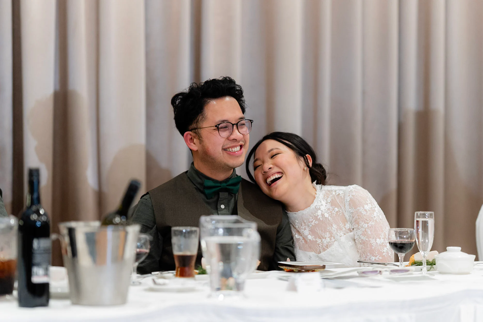 Joy leaning on Ron while they laugh through the speeches