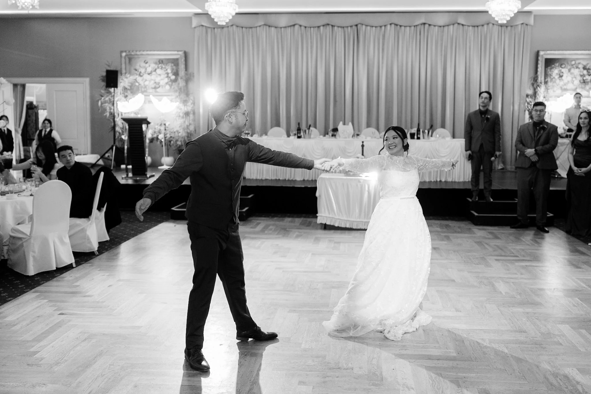 A wide black-and-white view of Ron and Joy's first dance