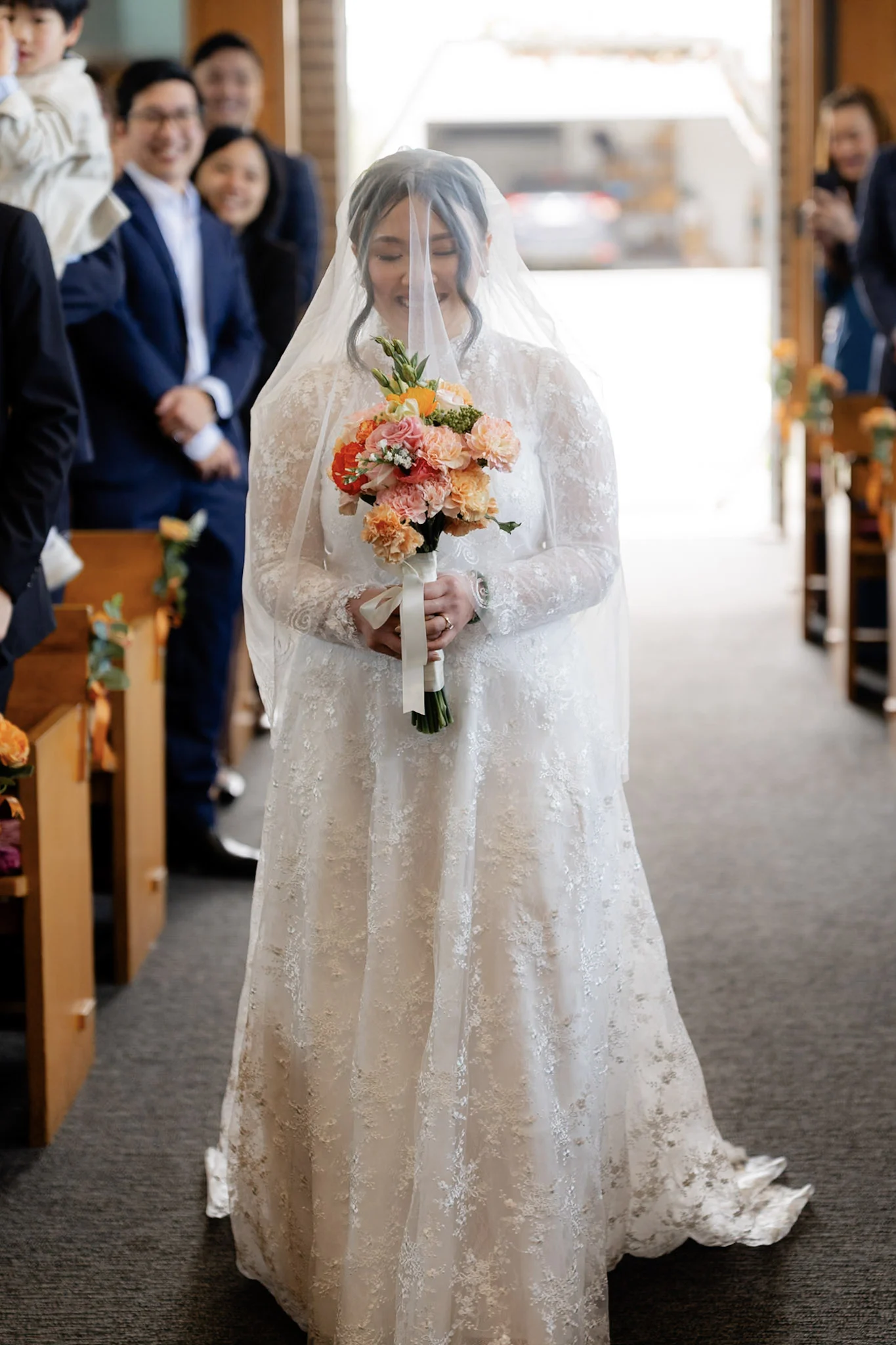 Joy walking down the aisle with her bouquet