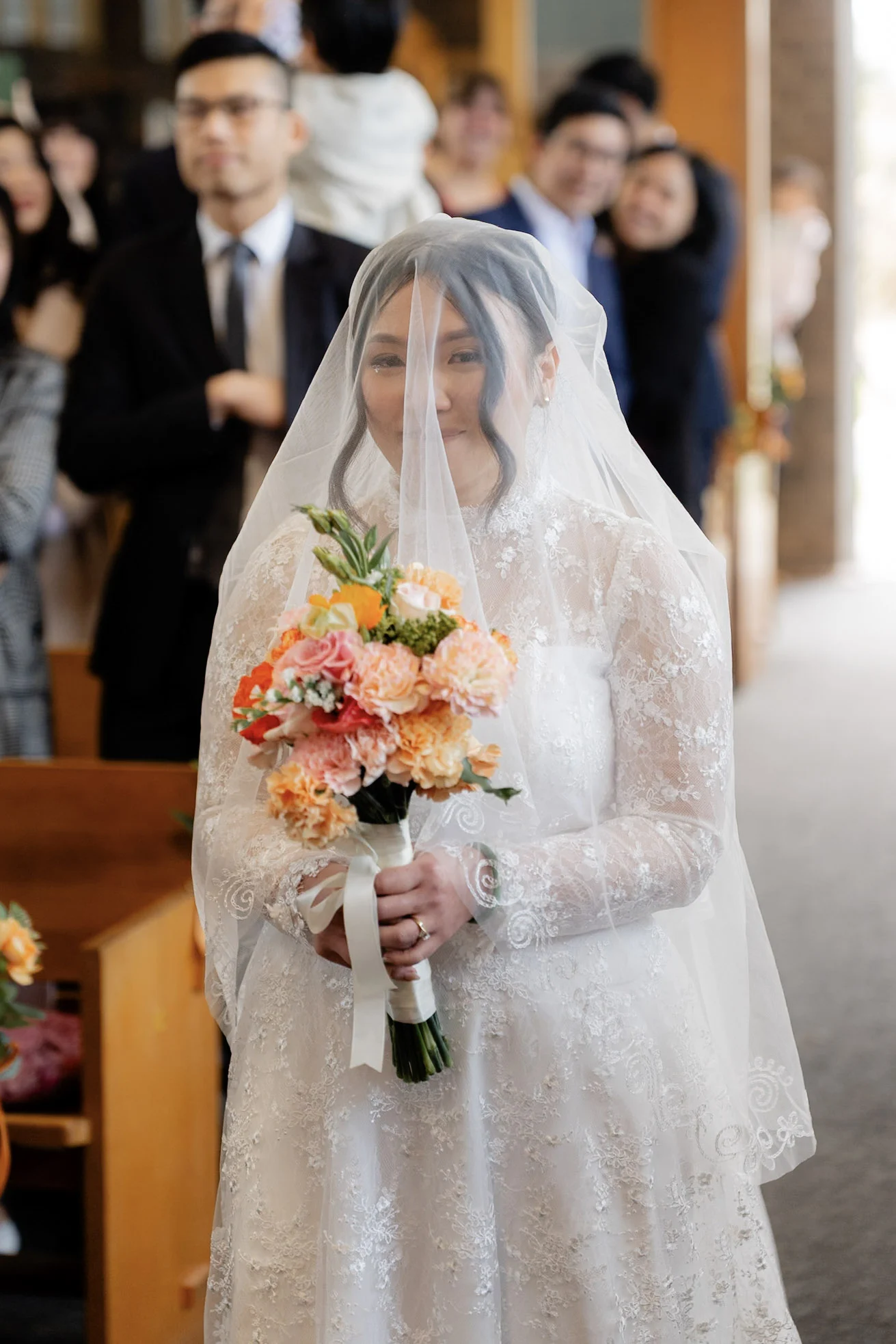 Joy smiling as she arrives at the front of the church