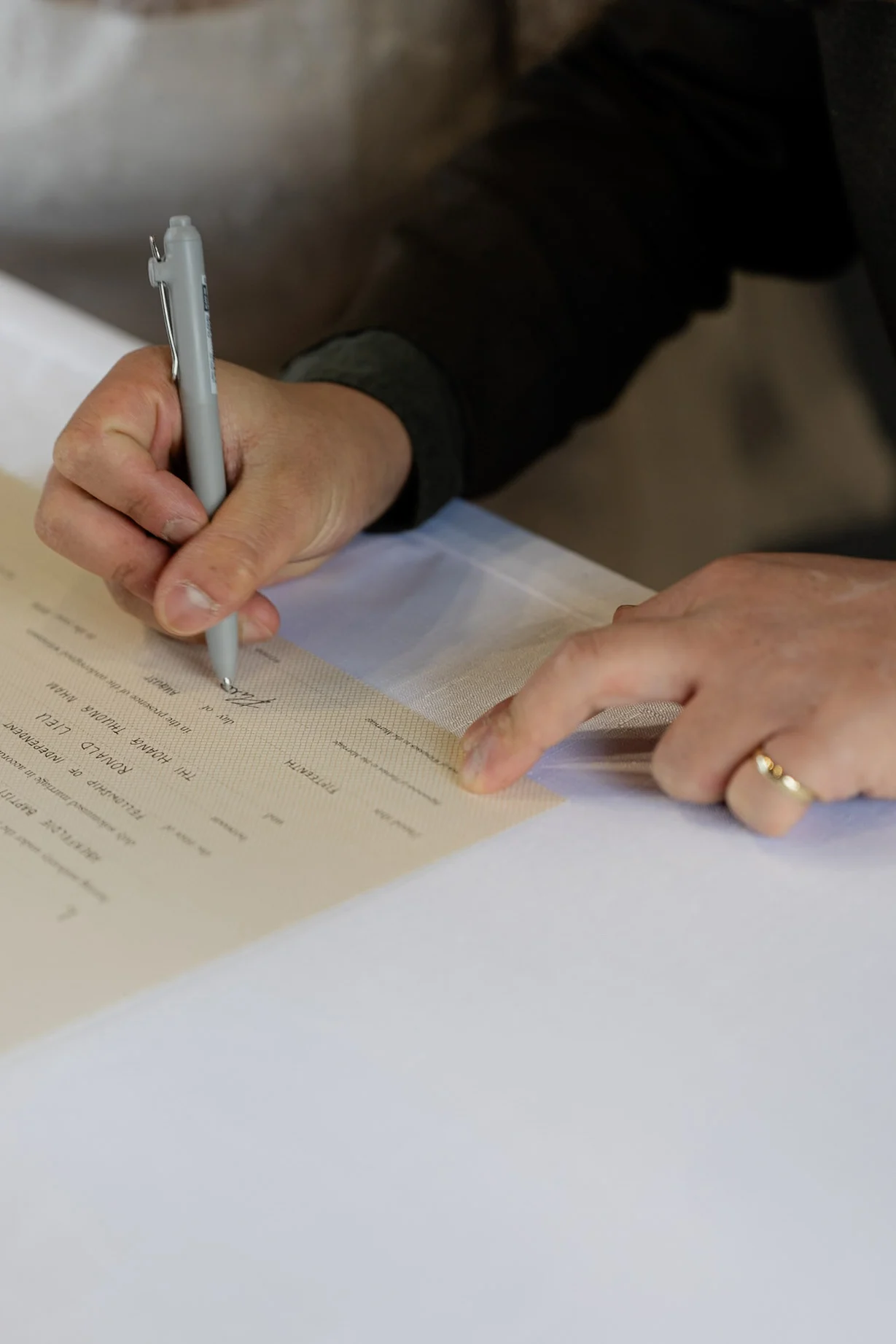Ron and Joy signing their marriage certificate