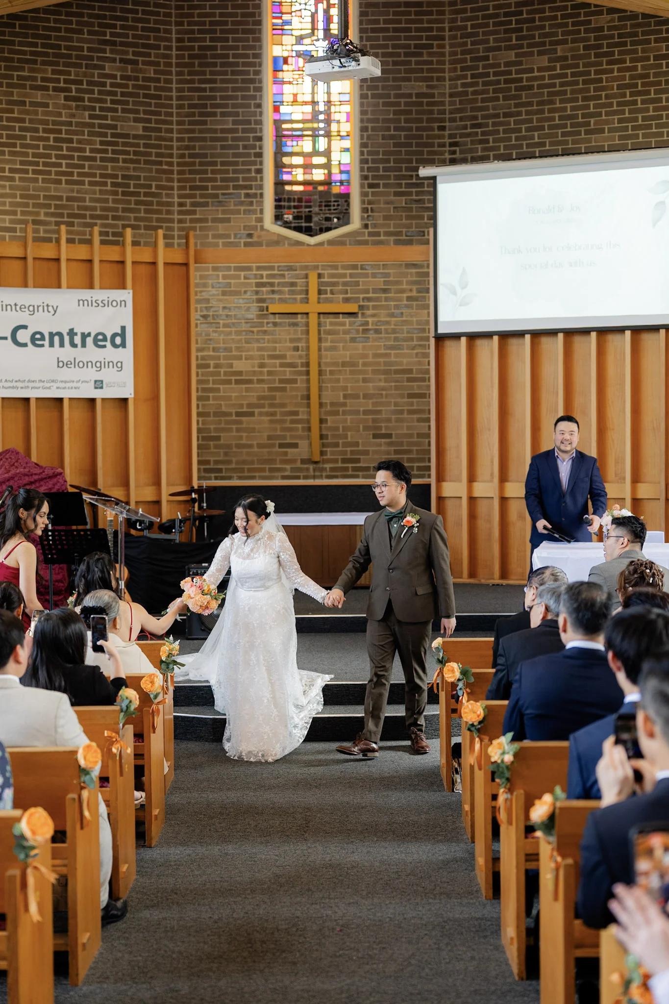 Ron and Joy walking back up the church aisle as newlyweds