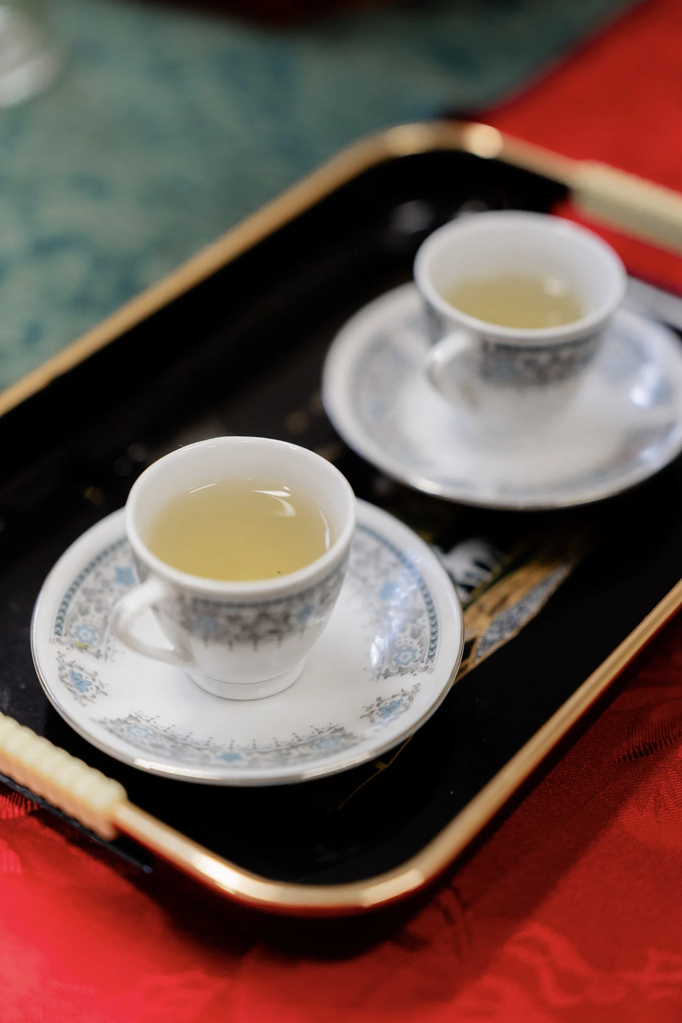 Two porcelain cups of tea ready for the family ceremony