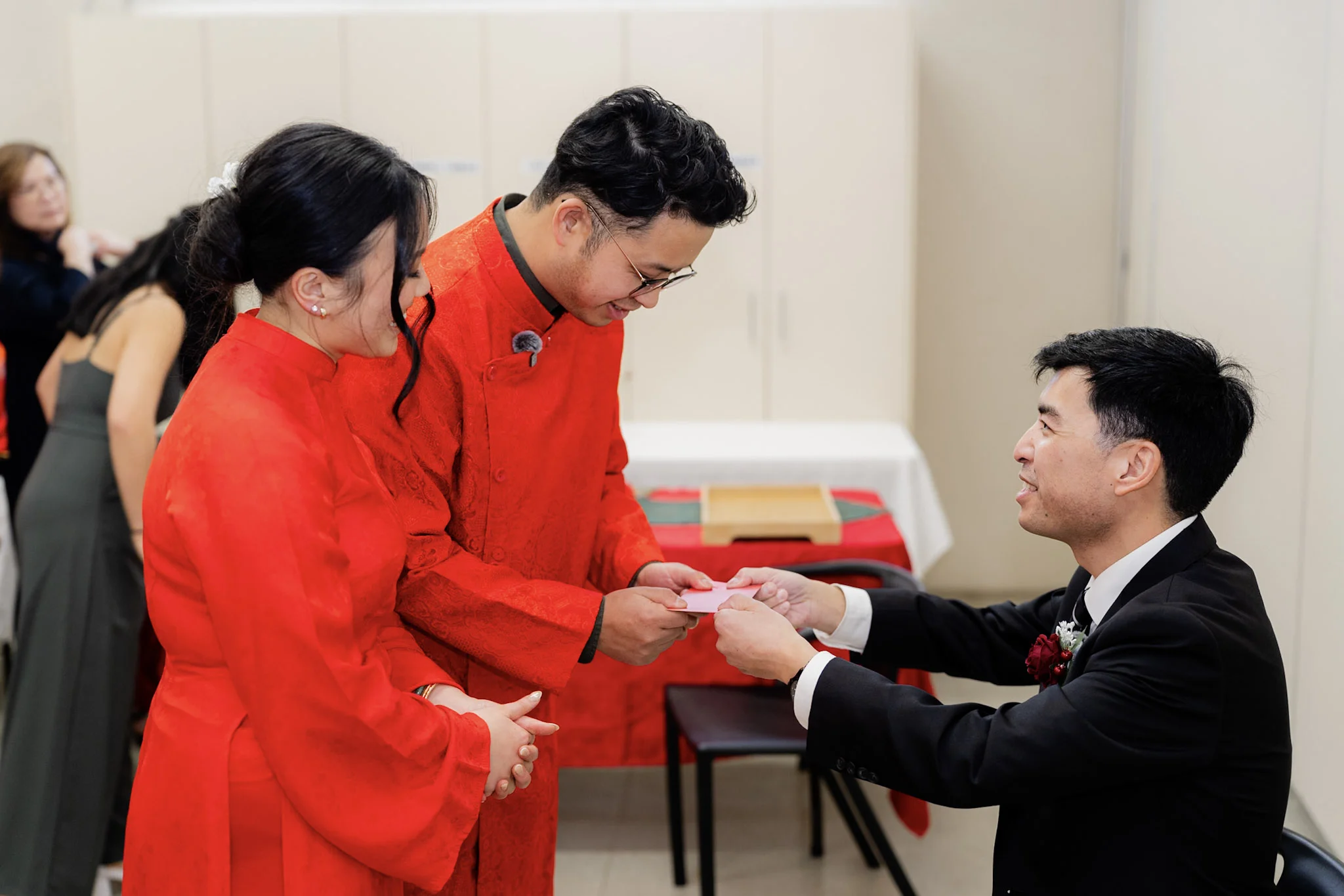 Ron and Joy serving tea together to a family member