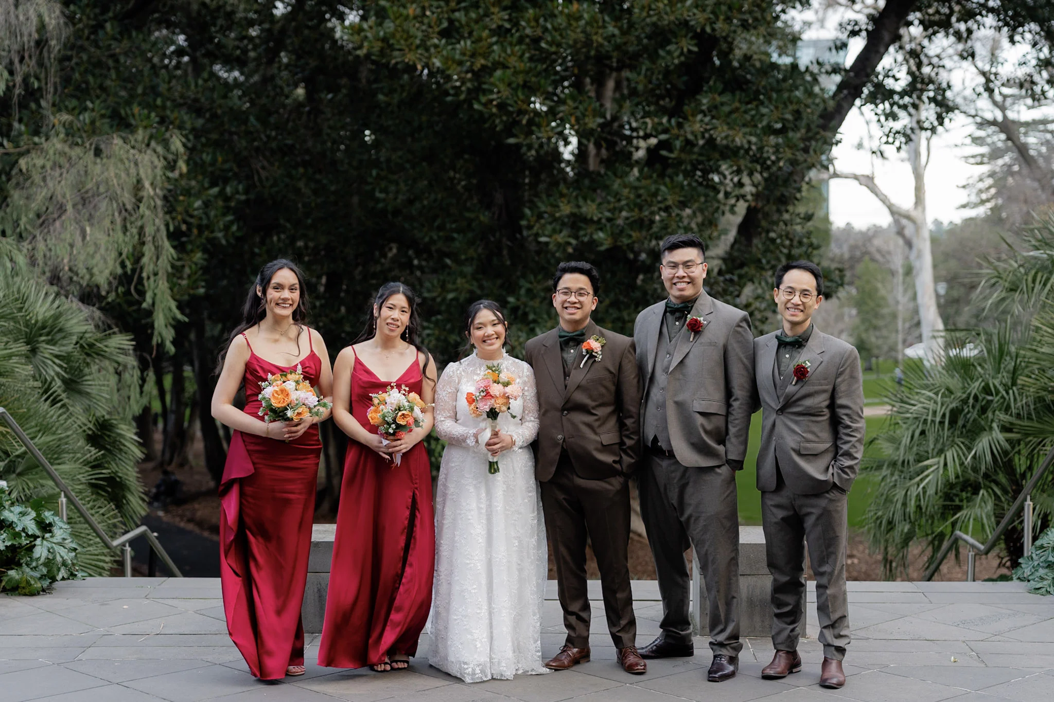Ron and Joy with their full wedding party in a Melbourne garden