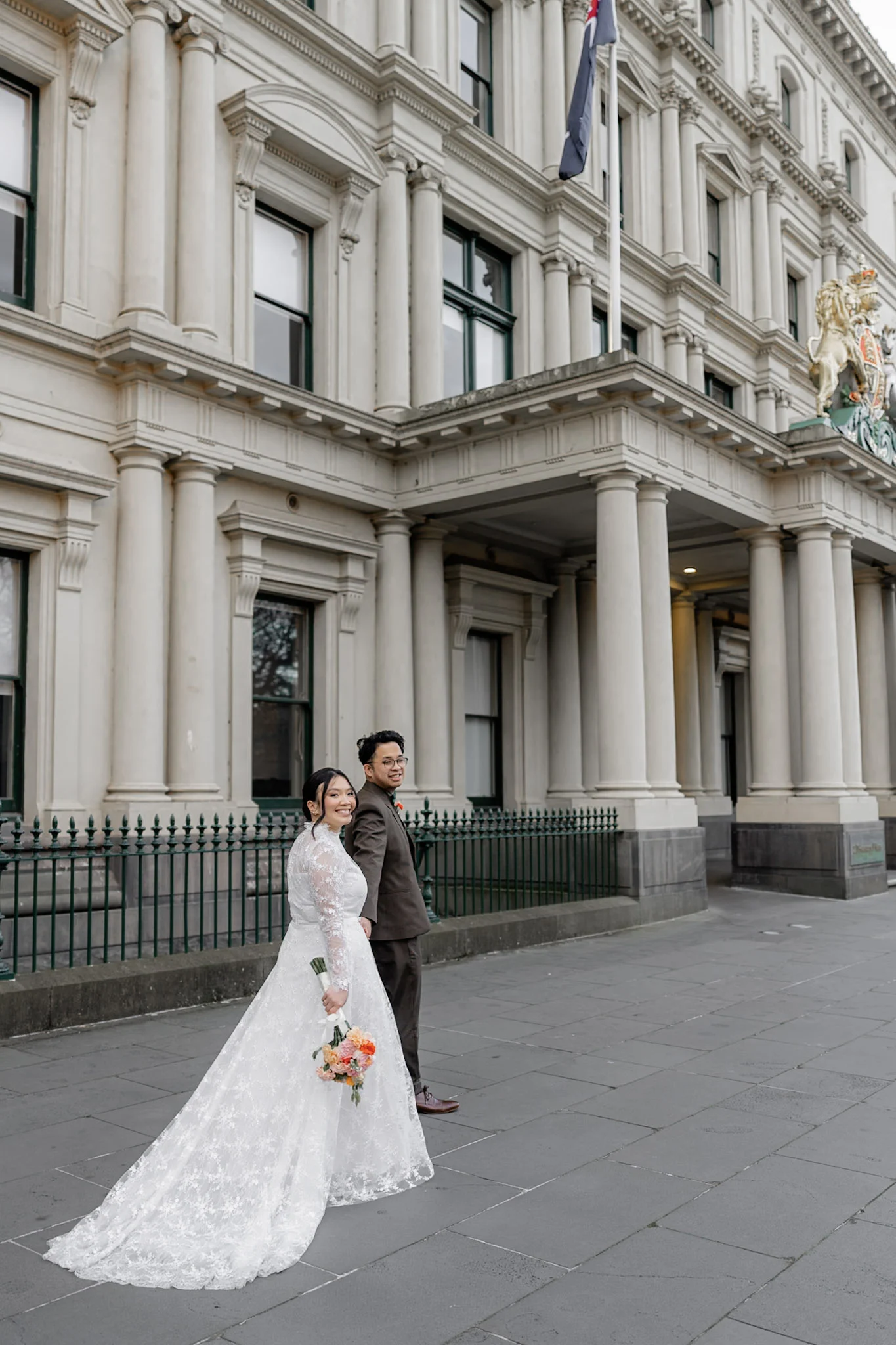 Ron and Joy holding each other against Melbourne architecture