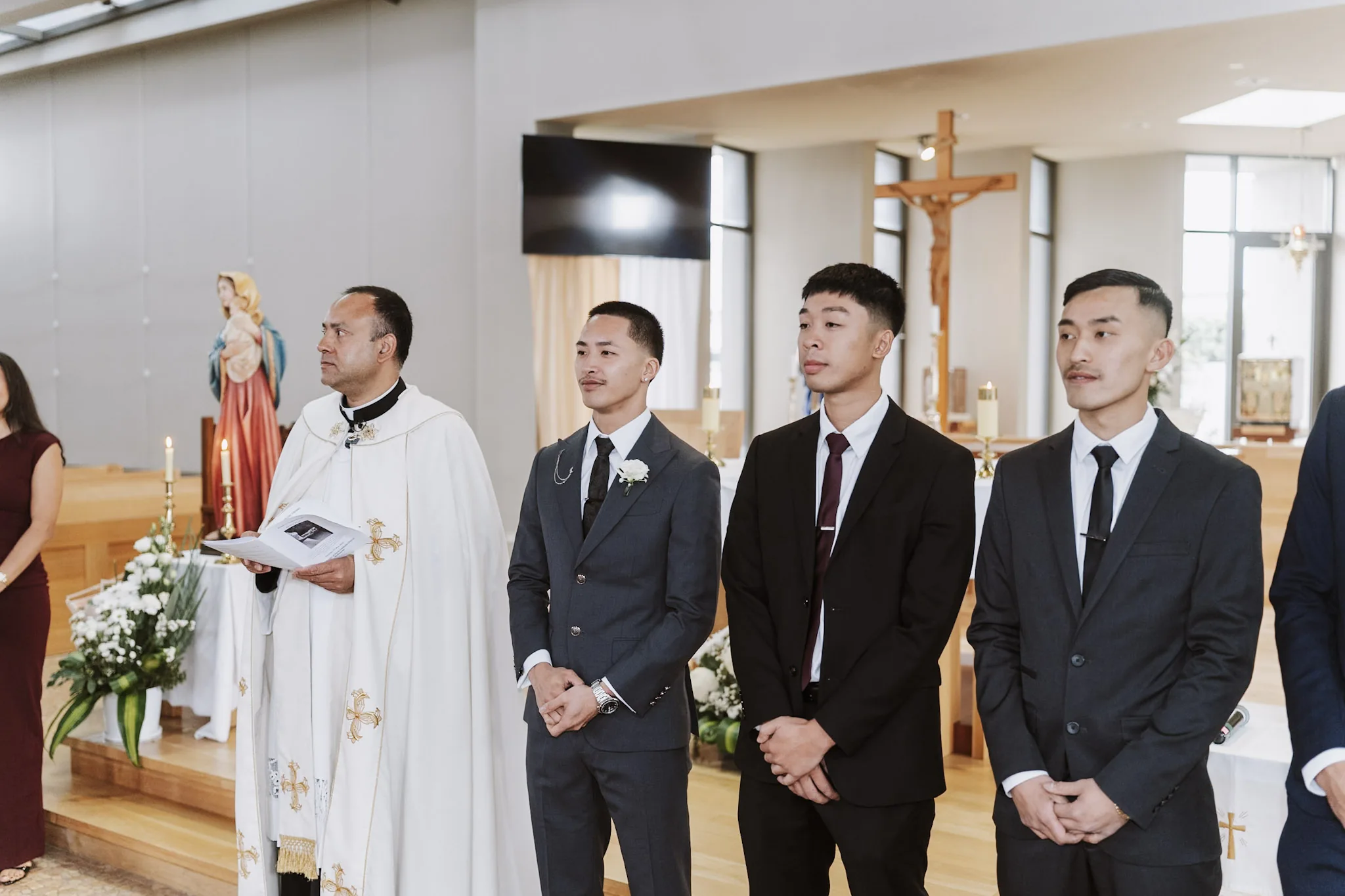Kevin and his groomsmen waiting beside the priest