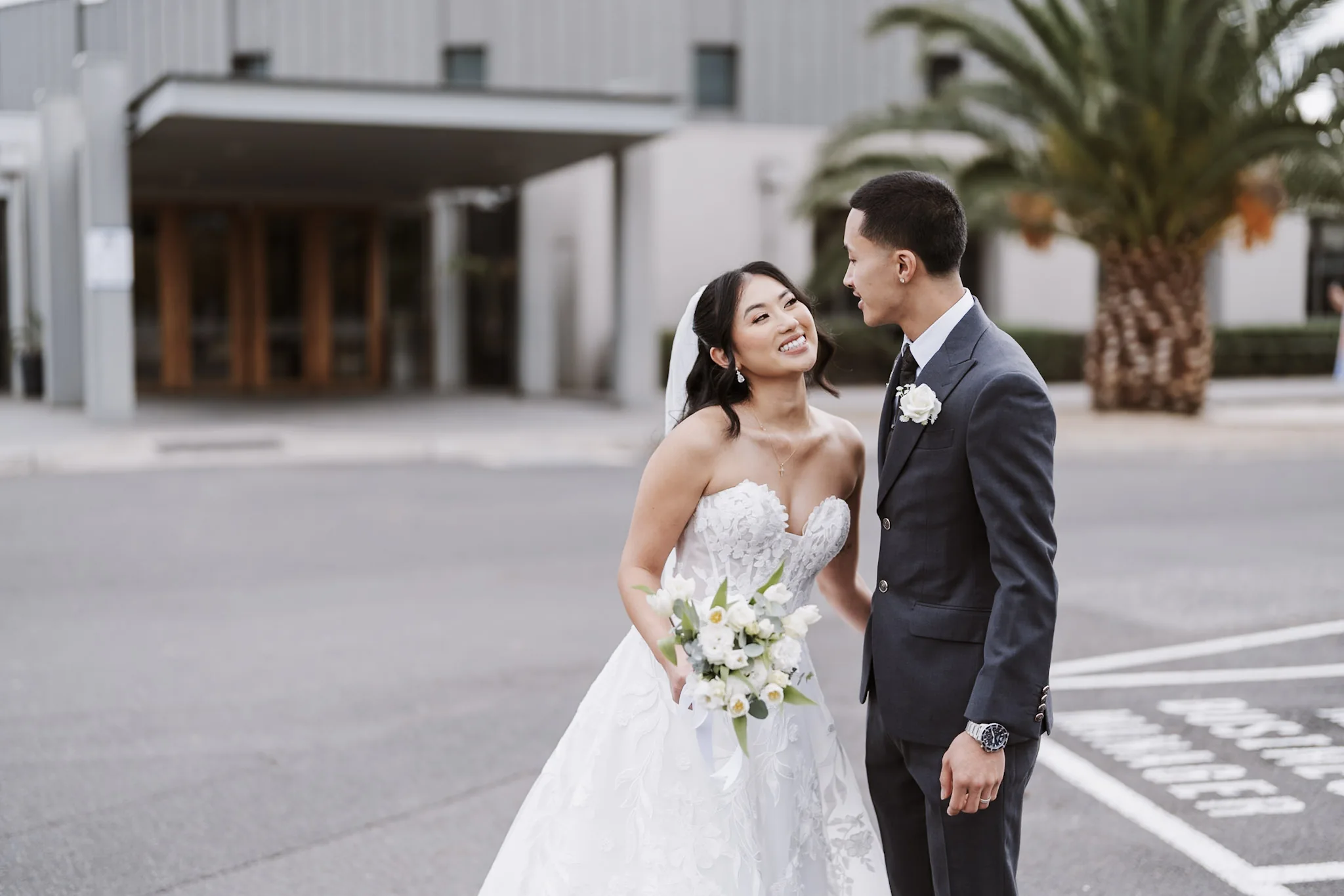 Kevin and Tee smiling at each other outside the church