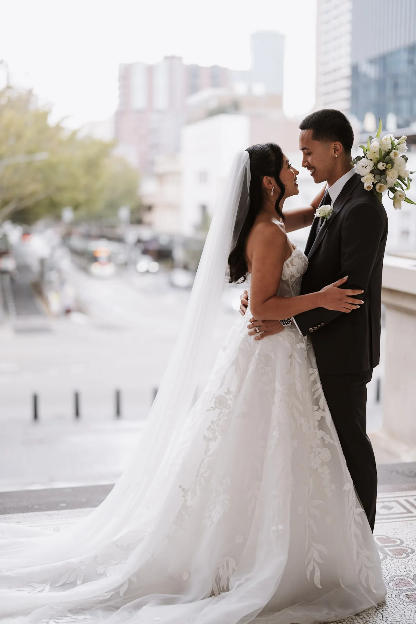 Kevin and Tee embracing in the soft light at the edge of an arcade
