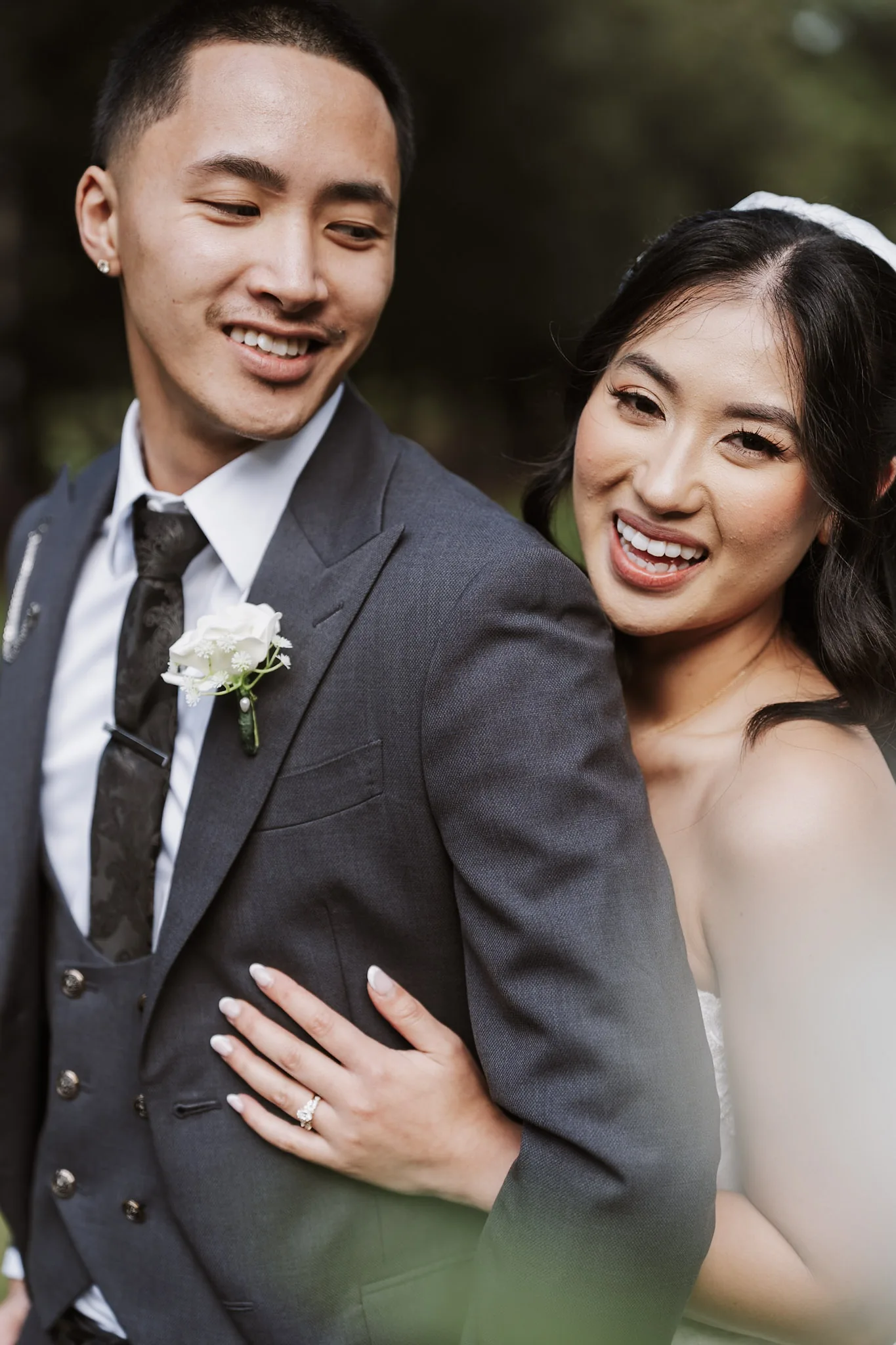 A close portrait of Kevin and Tee smiling together in the garden