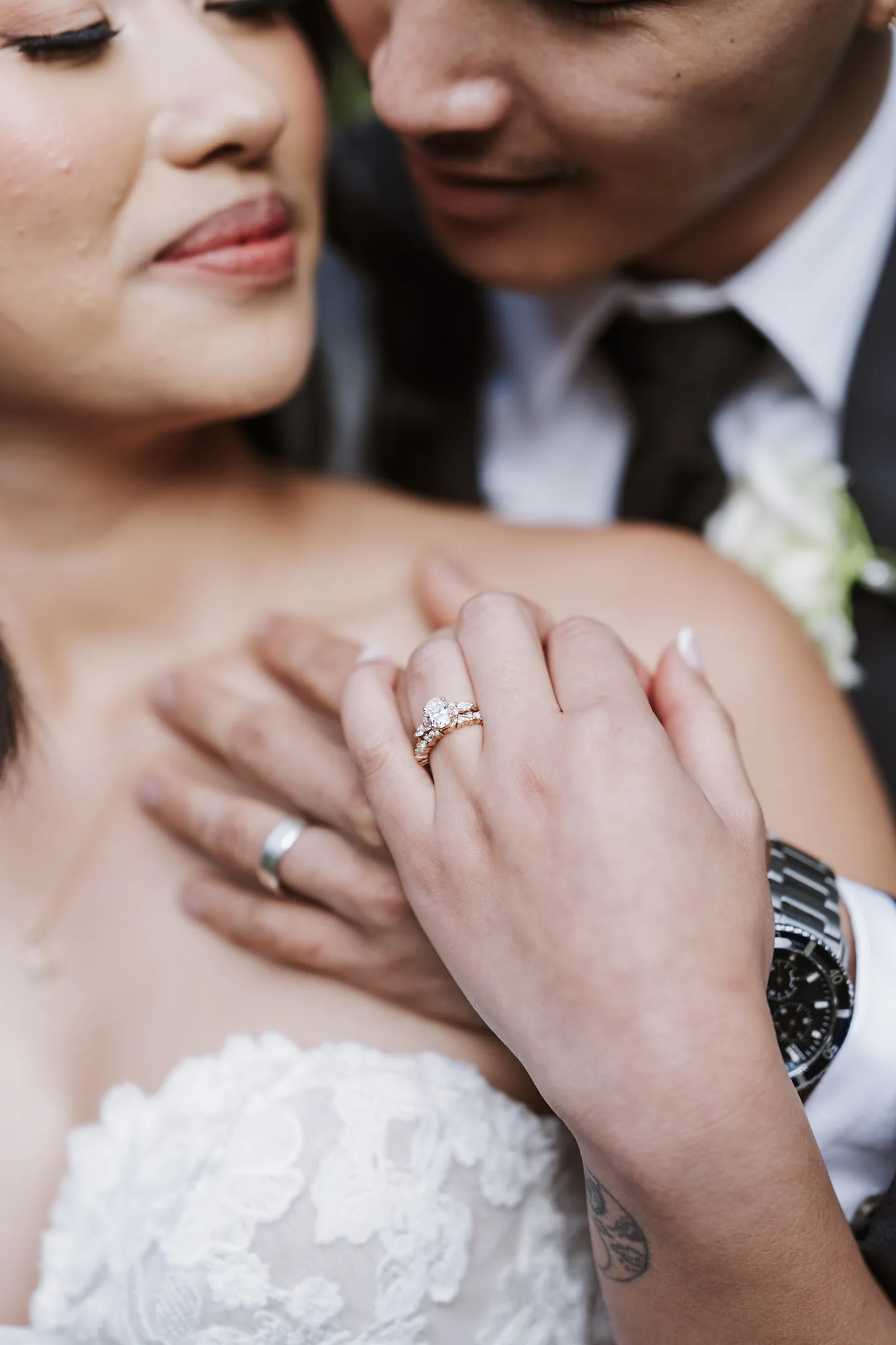 Tee's wedding ring resting on Kevin's shoulder in a close embrace
